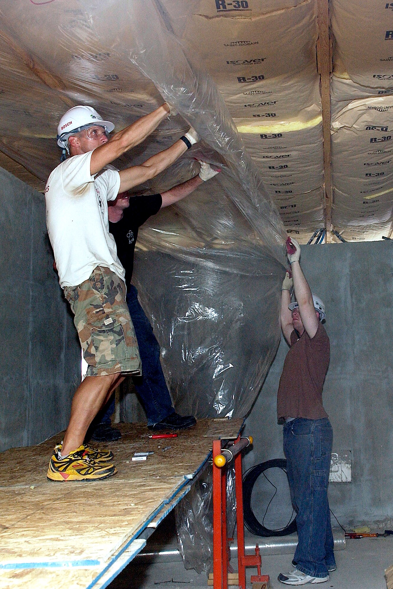 Airmen from across the 8th Fighter Wing at Kunsan Air Base, South Korea, work on the interior portion of a Habitat for Humanity home Aug. 1 in Gunsan City, South Korea. Airmen from Kunsan AB and Korean university students worked together for a week building Habitat for Humanity homes for Gunsan City families. (U.S. Air Force photo/Senior Airman Giang Nguyen) 
