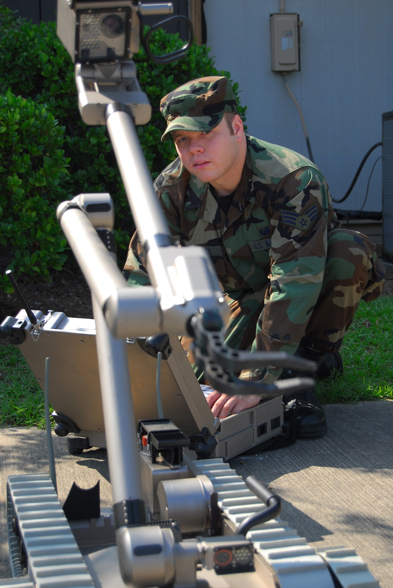 Senior Airman Justin Voorhees, 23rd Civil Engineer Squadron Explosive Ordnance Disposal technician, operates the manipulator arm on a bomb disposal robot Aug. 1 at the EOD flight’s offices.  Robots allow technicians to survey dangerous devices from a much safer distance. In the past, EOD technicians needed to put on a protective suit and visually inspect them. (U.S. Air Force photo By Tech. Sgt. Parker Gyokeres)