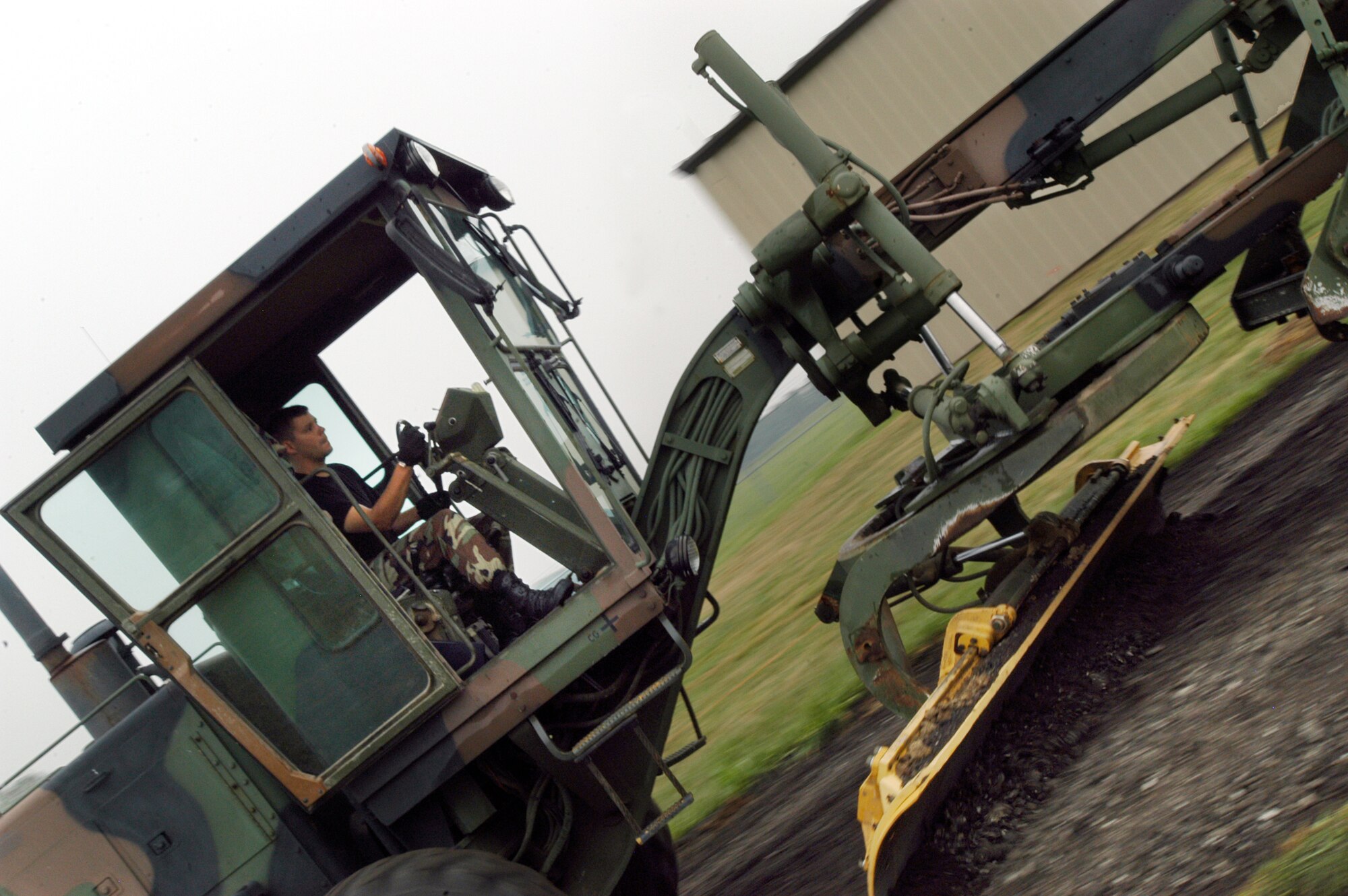 GRISSOM AIR RESERVE BASE, Ind. -- Staff Sgt. Josh Moormann, 434th Civil Engineering Squadron equipment specialist, drives a grader over what will become a road in the munitions storage compound. The road is being built to allow for better access to the munitions storage facility for both transport and emergency vehicles. (U.S. Air Force photo/Staff Sgt. Mark R. W. Orders-Woempner)