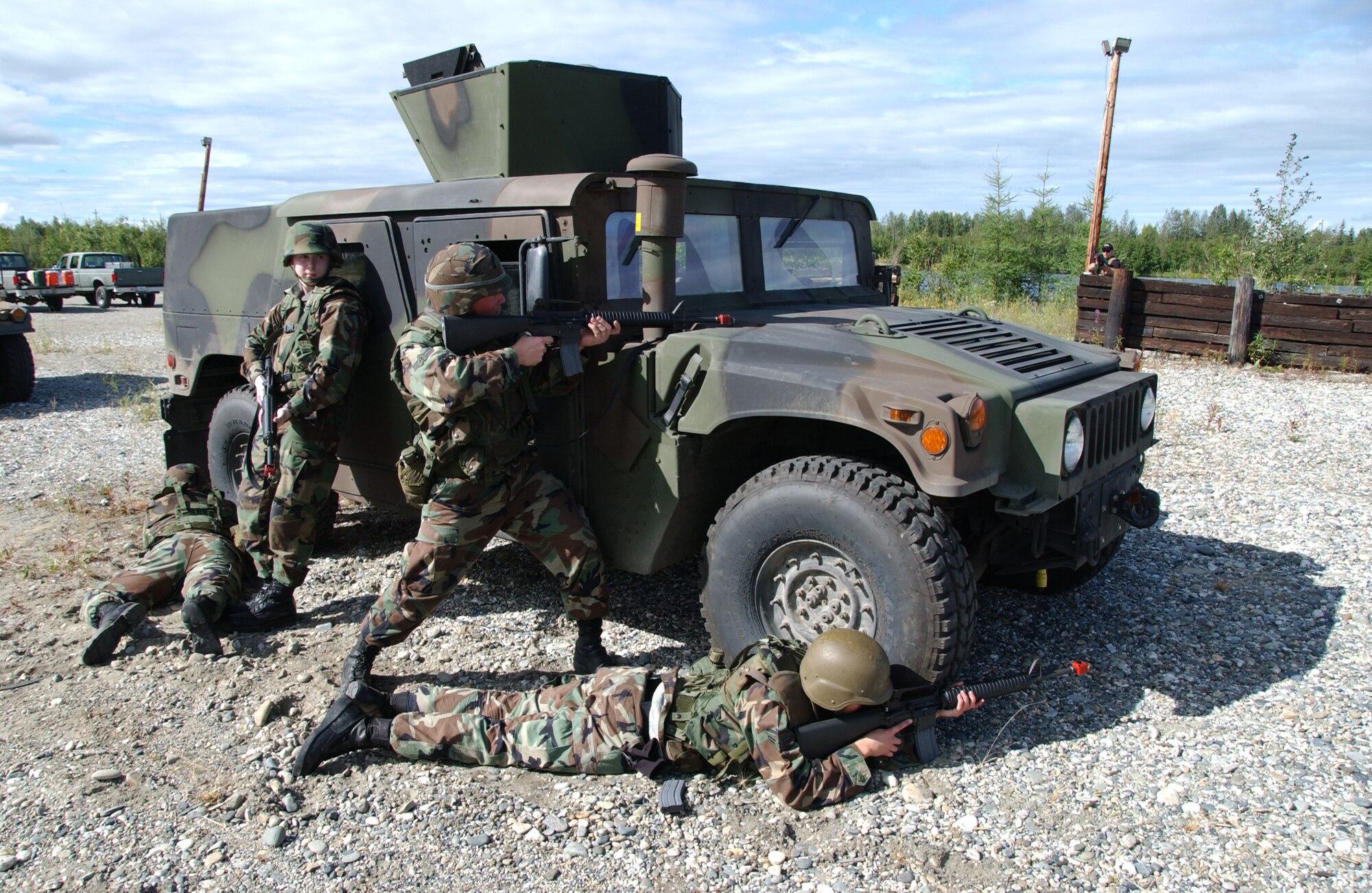 EIELSON AIR FORCE BASE, Alaska -- Four airmen demonstrate where to position themselves after exiting a Hummer while taking enemy fire during combat skills training August 3, 2007. This training allows airmen to learn the skills necessary to perform and adapt in a combat environment while deployed to an overseas location.  (U.S. Air Force photo by Airman 1st Class Christopher Griffin)