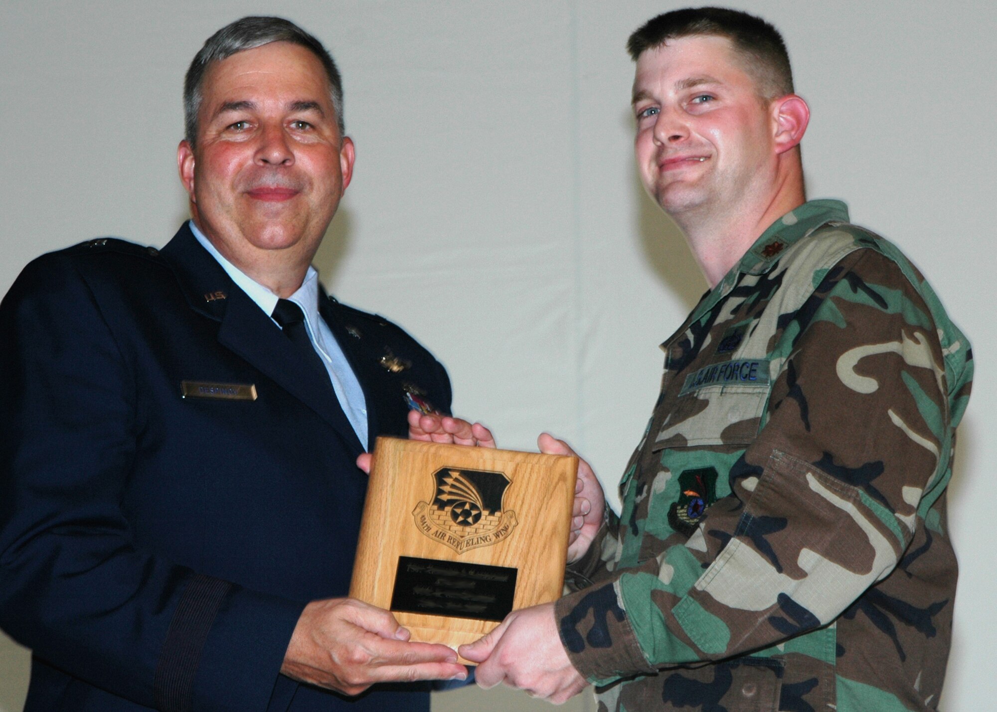 GRISSOM AIR RESERVE BASE, Ind., -- Brig Gen. Dean Despinoy, 434th Air Refueling Wing commander, left, presents a plaque to Maj. John Dwyer, 434th Services Flight commander, recognizing him as the Wing's Officer of the Quarter. (U.S. Air Force photo/Tech. Sgt. Doug Hays)