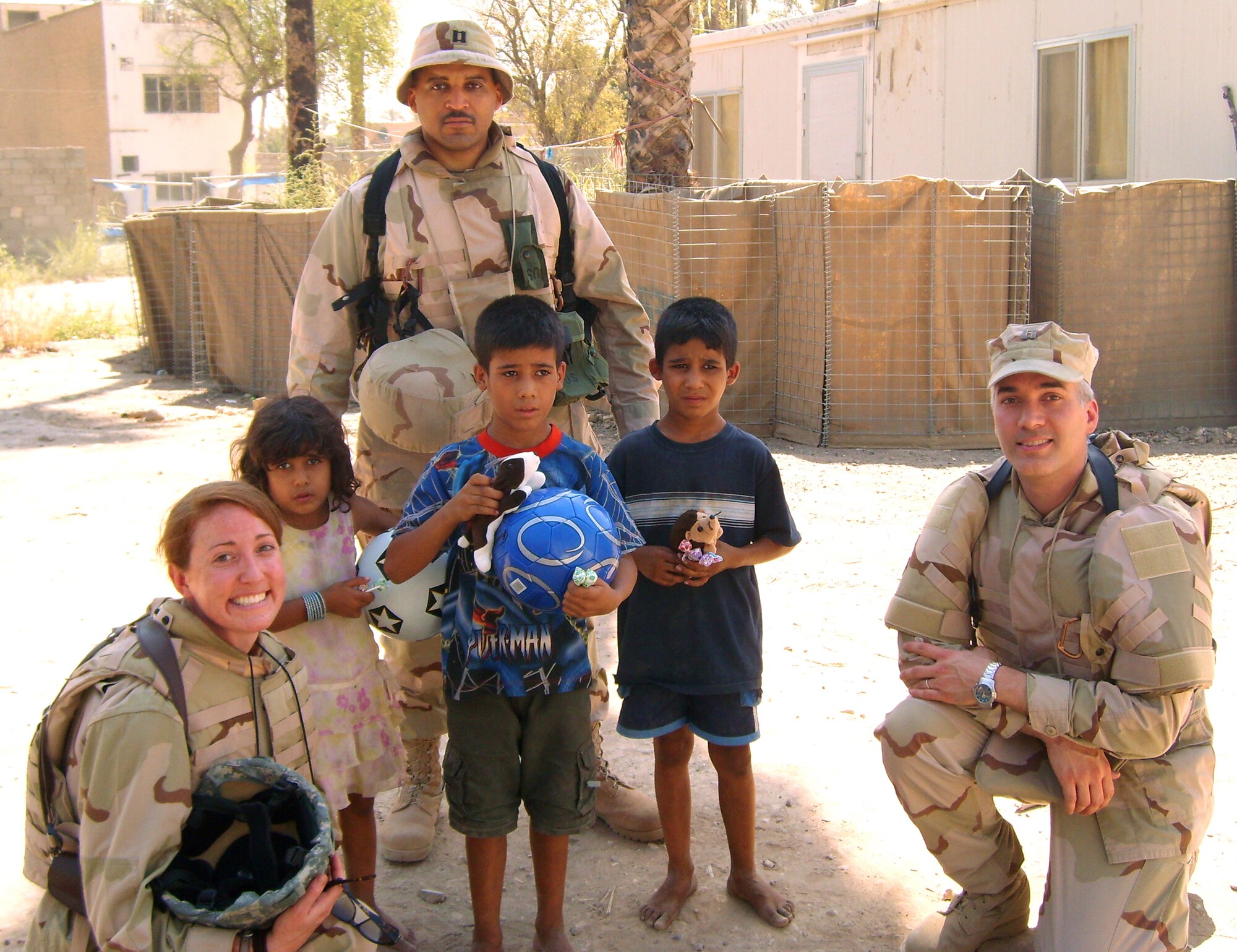 BAGHDAD -- Iraqi children hold donated toys they received as part of the Iraqi School Donation Program. Captains' Ellen Ellis, Tim Boykin and Jim Wacker helped make the delivery of donated goods to an orphanage. (Courtesy photo)