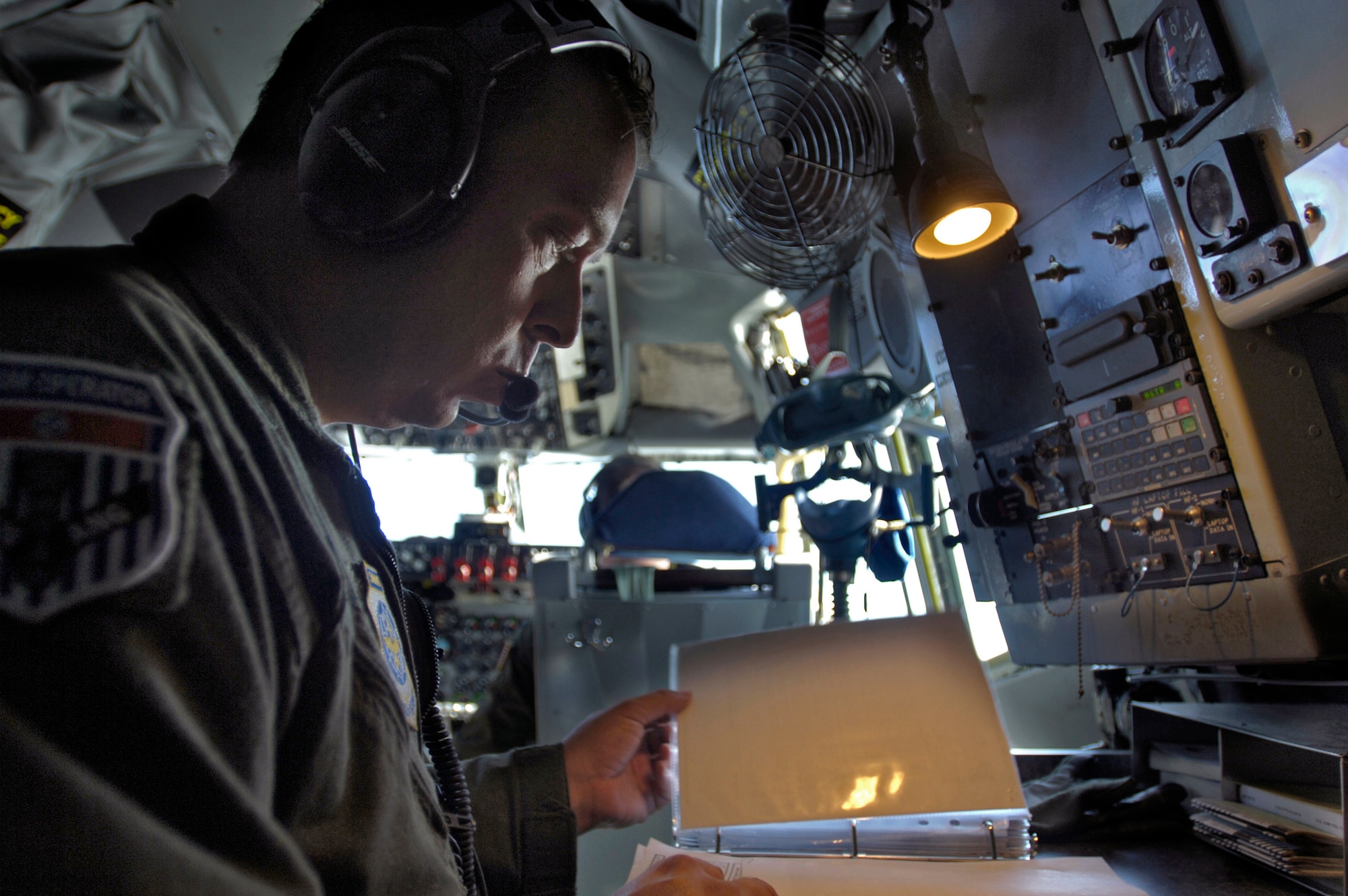 Master Sgt. Wayne Atkins, a KC-135 Stratotanker flight engineer, fills in flight documents Aug. 1 during a preflight inspection at Forward Operating Location, before a refueling mission over the Pacific Ocean. The Tennessee Air National Guard's 134th Air Refueling Wing deployed to the location to provide aerial refueling support for surveillance missions flown by deployed E-3 Sentry airborne warning and command systems aircraft. (U.S. Air Force photo/Tech. Sgt. Cecilio Ricardo)