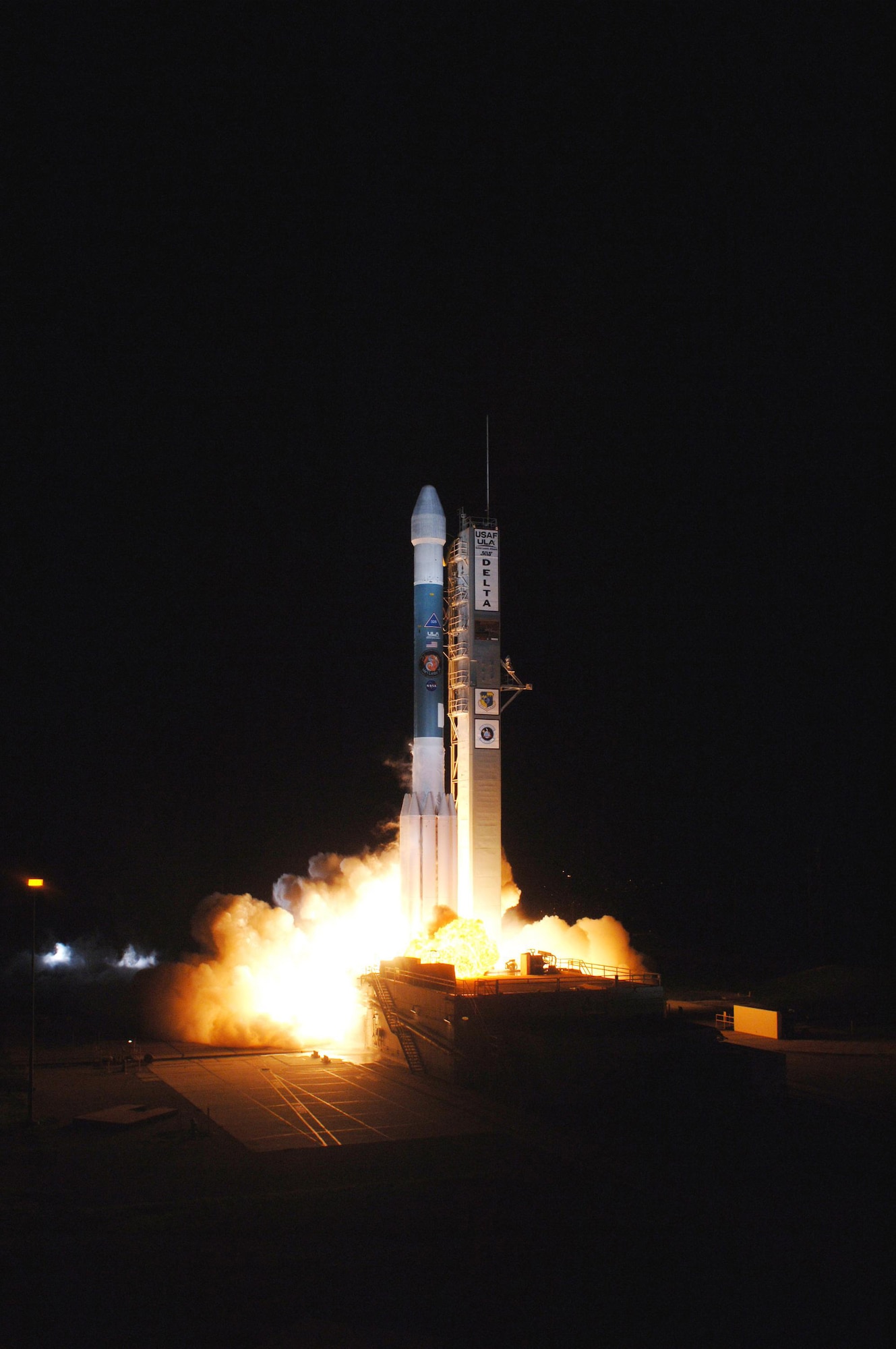 The Delta II rocket carrying NASA's Phoenix Mars lander lifts off Aug. 4 amid billows of smoke on Pad 17-A at Cape Canaveral Air Force Station, Fla. Phoenix will land in icy soils near the north polar, permanent ice cap of Mars and explore the history of the water in these soils and any associated rocks, while monitoring polar climate. Landing on Mars is planned in May 2008 on arctic ground where a mission currently in orbit, Mars Odyssey, has detected high concentrations of ice just beneath the top layer of soil. (NASA photo/Tony Gray and Robert Murray)