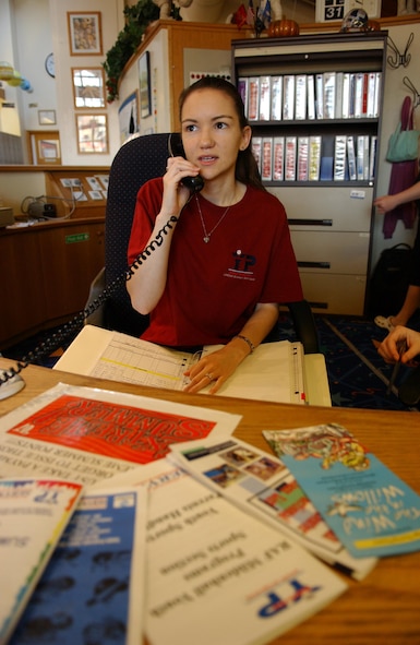 Michelle Ackley performs her daily duties as a Desk Clerk at the RAF Mildenhall Youth Center. (U.S. Air Force photo by Staff Sgt. Tyrona Pearsall)