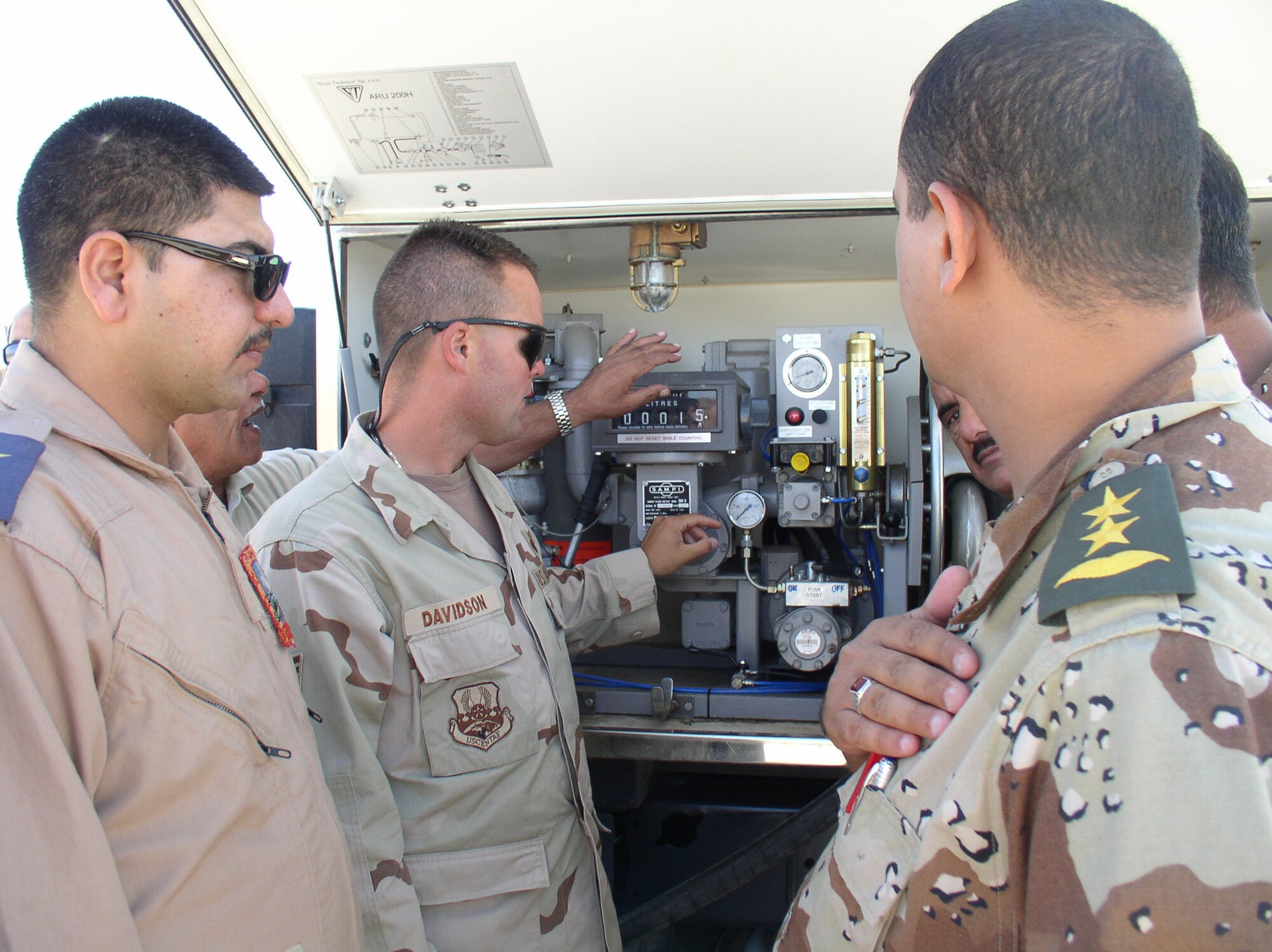 Tech Sgt. Randy Davidson, a deployed instructor with the 366th Training Squadron Fues Flight, shows the first class of Iraqi fuels students a piece of fuels equipment. (U.S. Air Force photo)