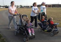 MINOT AIR FORCE BASE, N.D. -- Military spouses and their children participate in a "HAWC Walk" sponsored by the Health and Wellness Center here. The event was part of Community Cares part, which runs through Aug 31, and featured awards and prizes. Community cares month focuses on supporting families of deployed Airmen. (U.S. Air Force photo by Airman 1st Class Cassandra Jones)