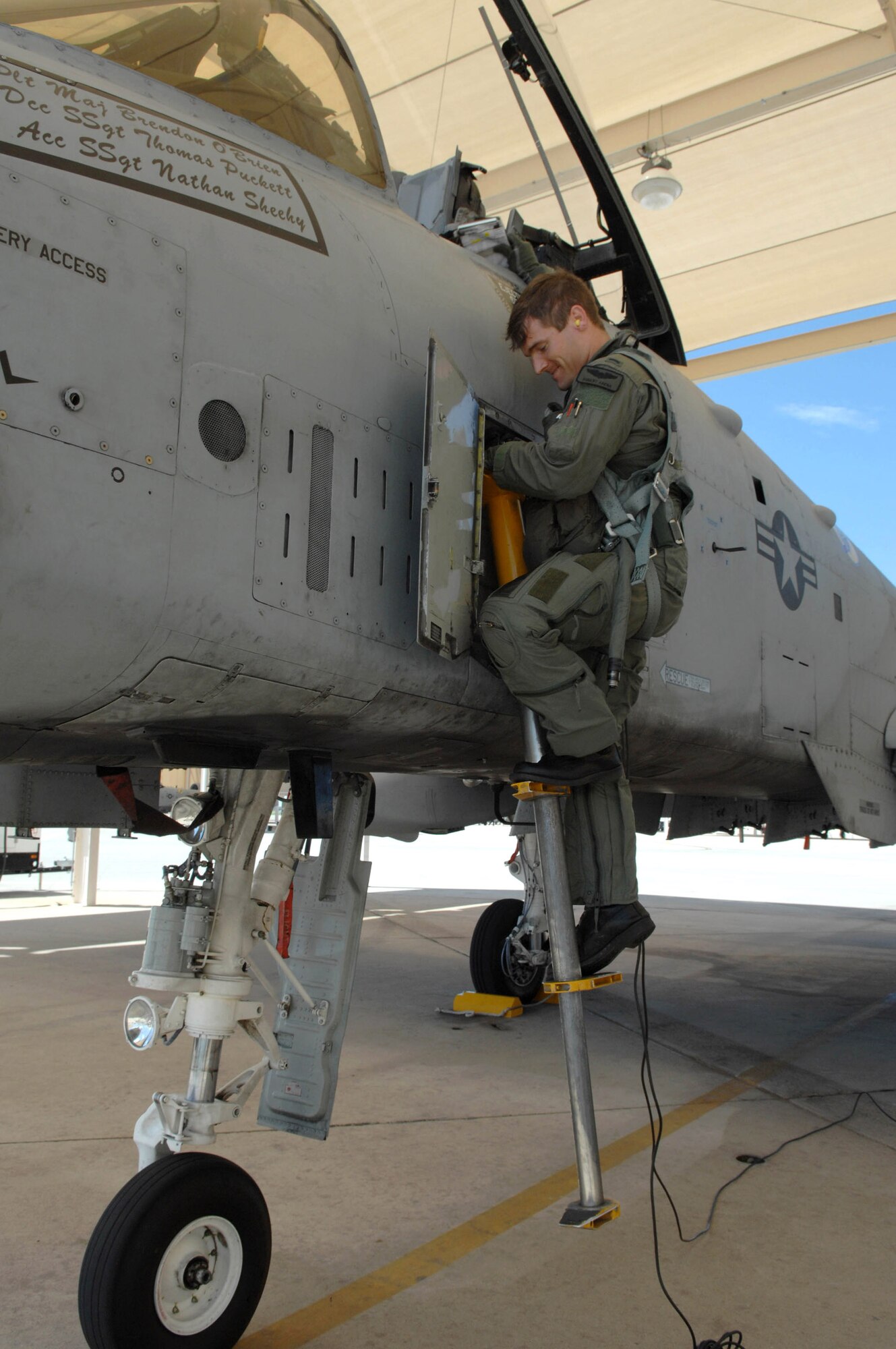 Second Lieutenant Robert Arena climbs out of his A-10 Thunderbolt II, after being the first pilot to land after completing the A-10C pilot initial qualification course Aug. 2 at Davis-Monthan Air Force Base, Ariz. During the seven-month-long course, the training focused on the new A-10C platform which replaced the A-10A. The pilots also learned the basics of being attack pilot wingmen, which included flying in formation to provide mutual support, communicate with radios and kill the assigned target on the first attempt. Lieutenant Arena is an A-10 pilot with the 357th Fighter Squadron. (U.S. Air Force photo/Senior Airman Christina D. Ponte)