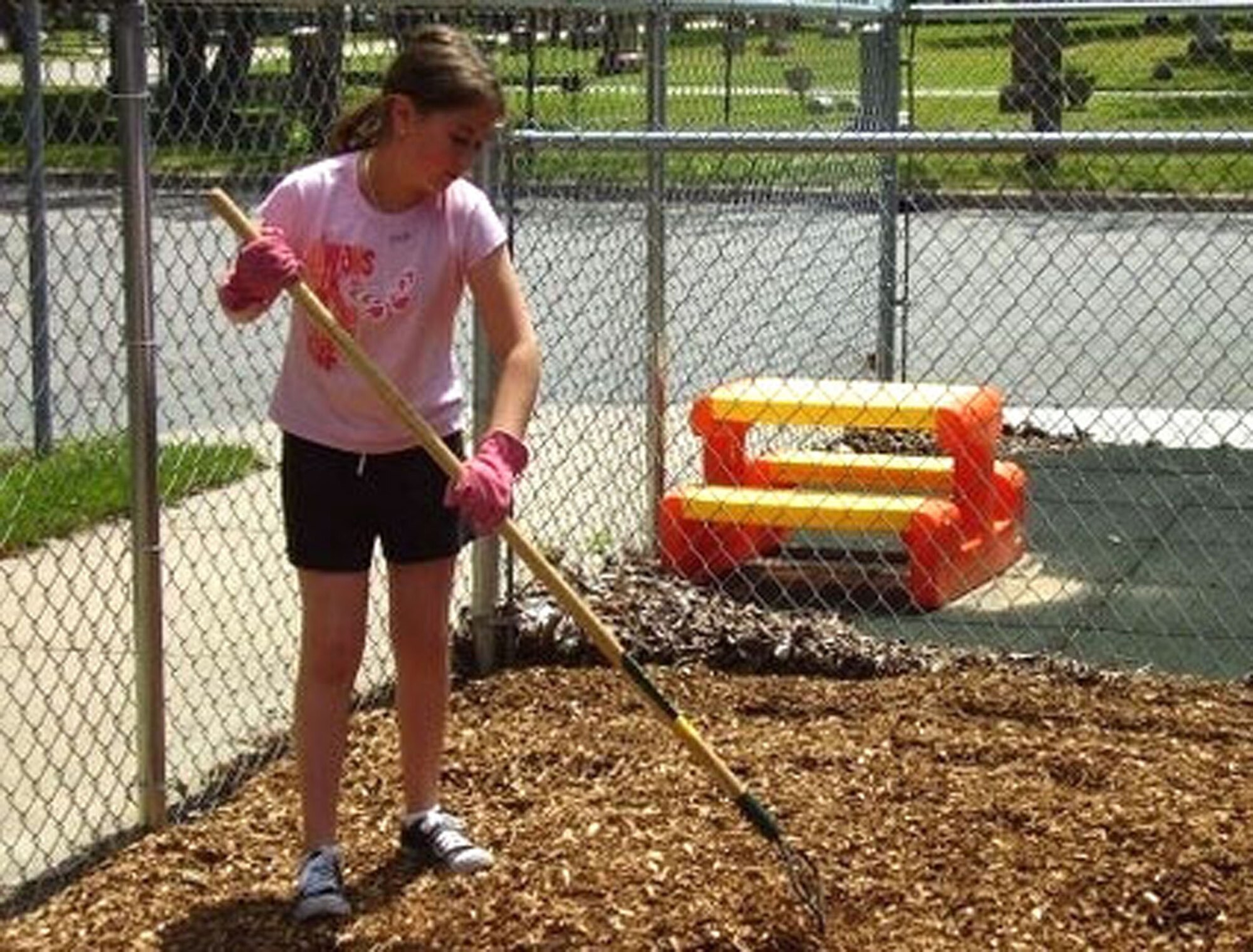 Little Warrior Karri, landscapes a school playground during a "Week of Hope" July 7 to 14. The program provides groups a chance to  do volunteer work that helps the needy. Volunteers from the Malmstrom Catholic and Protestant parishes clocked 560 hours at 25 different worksites do jobs that varied from landscaping and cleaning to leading church programs and tutoring special needs students. The youth group at the Malmstrom base chapel hopes to travel to either Peru or Puerto Rico next year. (U.S. Air Force photo).