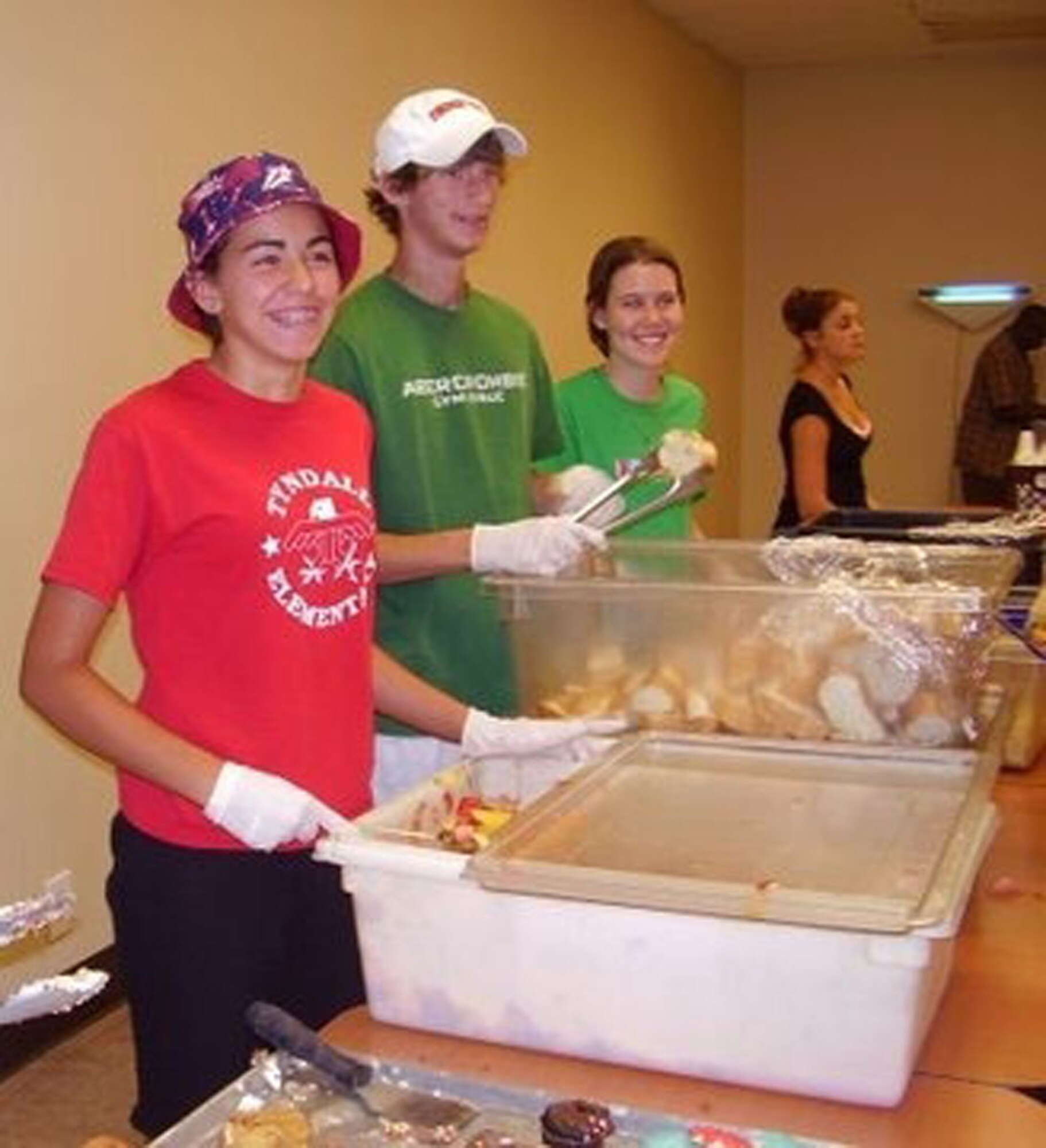 Youth volunteers at a "Week of Hope" July 7 too 14 serve food at a homeless shelter. The program provides groups a chance to  do volunteer work that helps the needy. Volunteers from the Malmstrom Catholic and Protestant parishes clocked 560 hours at 25 different worksites do jobs that varied from landscaping and cleaning to leading church programs and tutoring special needs students. The youth group at the Malmstrom base chapel hopes to travel to either Peru or Puerto Rico next year. (U.S. Air Force photo).