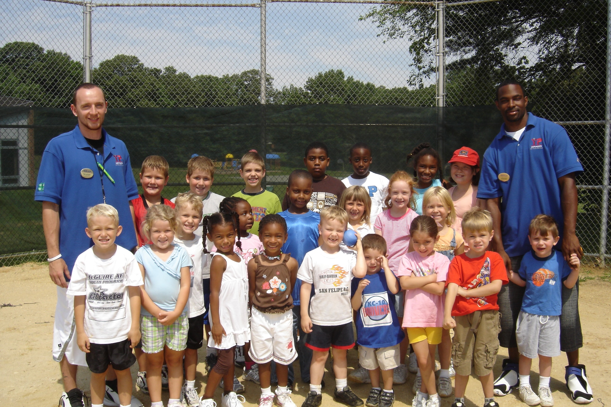 Left, Ronny Weihmann and Carlton Peete, both Emmanuel College, Ga., senior basketball players turned camp counselor interns, along with their campers during the McGuire Fit Factor Youth Camp program here. The five-week program was the first of its kind in the Air Force. Its mission is to help teach children to live an active life, and to instill lifelong fitness, obesity prevention and skill development.