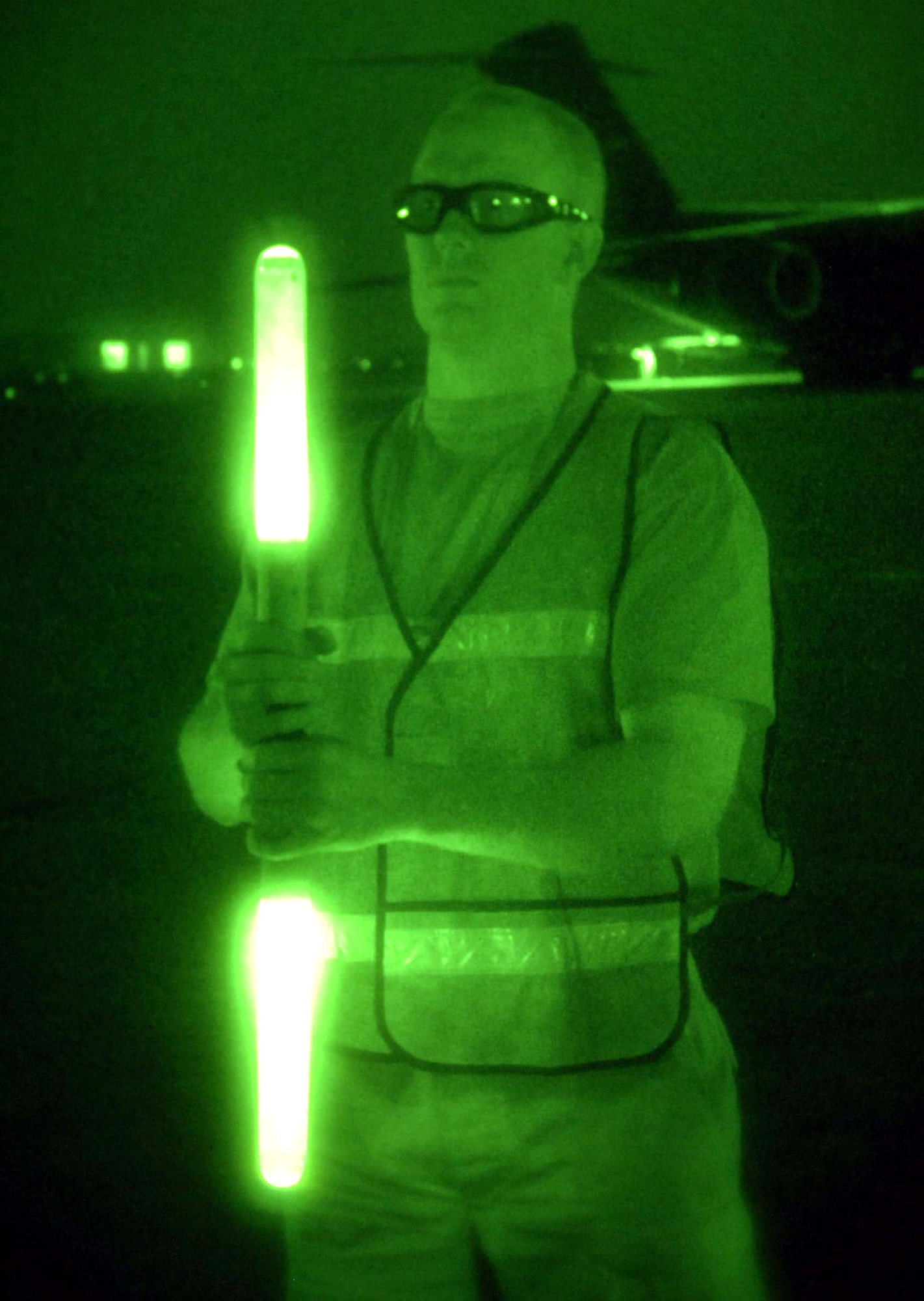 Staff Sgt. Jacob Whetstone holds a pair of marshalling sticks to signal a pair of UH-60 Blackhawk helicopters where to park July 30 at Baghdad International Airport in Iraq. The 447th Expeditionary Operations Squadron transient alert team coordinates all traffic on the military airfield here. An average day brings in more than 100 fixed and rotary wing aircraft. Sergeant Whetstone is a 447th Expeditionary Operations Squadron crew chief. (U.S. Air Force photo/Tech. Sgt. Russell Wicke) 
