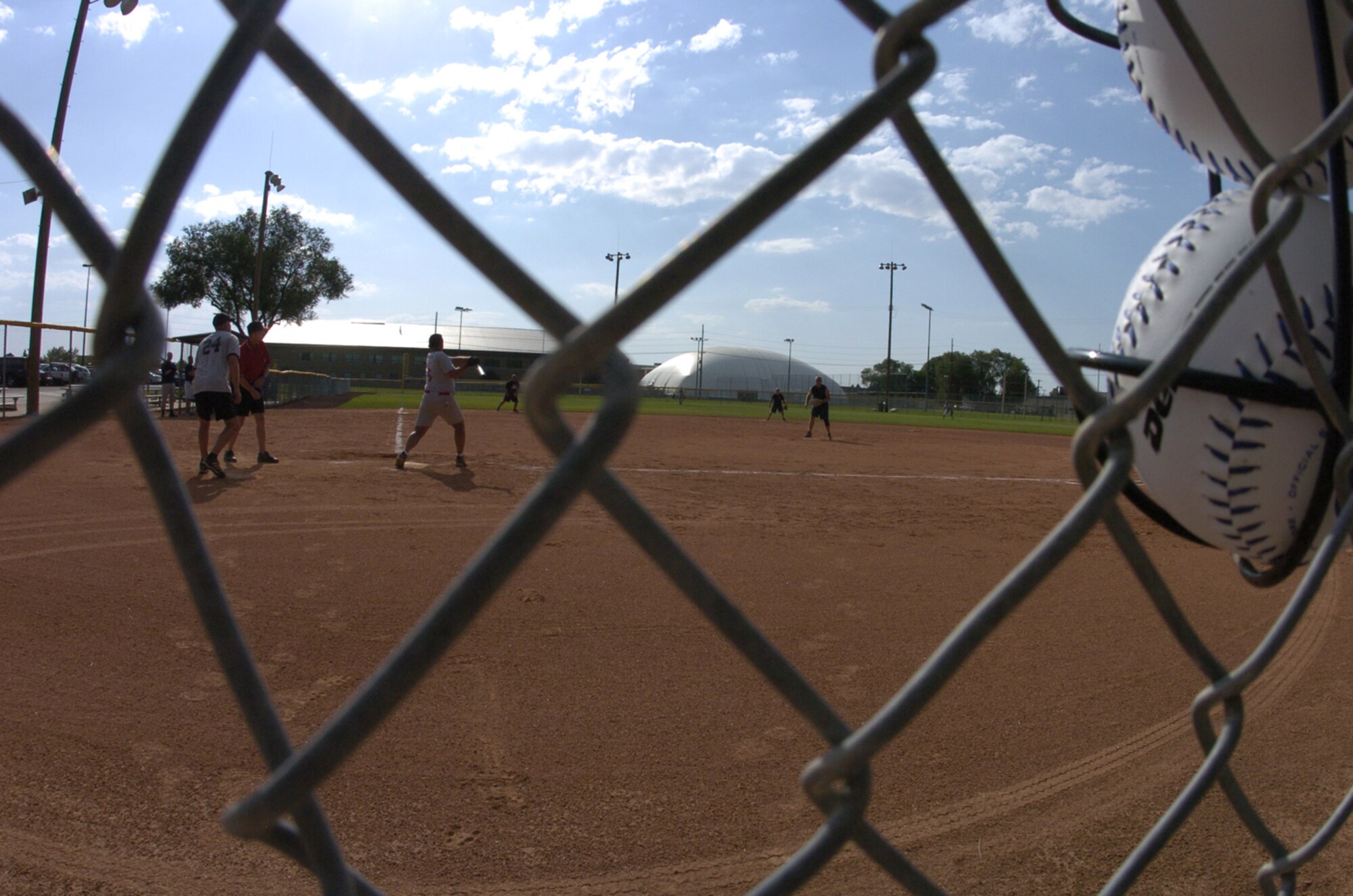 A member of the Civil Engineer Softball Team takes a swing during the Aug. 6, Hill Air Force Base Intramural Competition League Championship Game against Ammo. The CE Team, which advanced from the loser's bracket, won the first game 14-11.  The Ammo Team won the second game 26-24 securing the championship for Ammo. Members of the Ammo Team are looking forward to competing in a Layton, Utah, Community League in the fall. (Photo by Airman 1st Class Clay Murray)