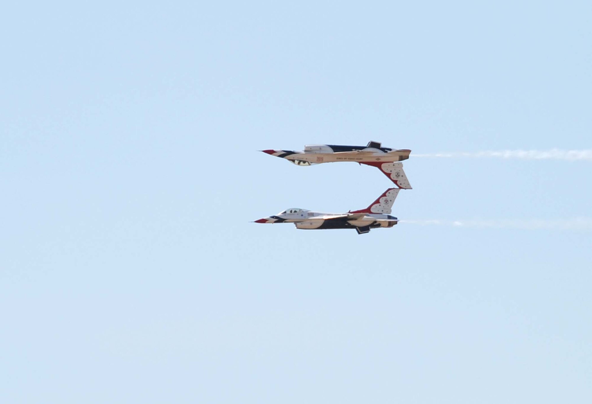 Thunderbirds aircraft “upside down No. 5,” piloted by Maj. Ed Casey, and aircraft No. 6, piloted by Maj. Samantha Weeks, perform a tight two-man maneuver where they almost seem to be touching vertical stabilizers. The reason Major Casey’s aircraft has an upside down No. 5 is because he performs many of the inverted maneuvers (Photo by Staff Sgt. Chad Thompson).