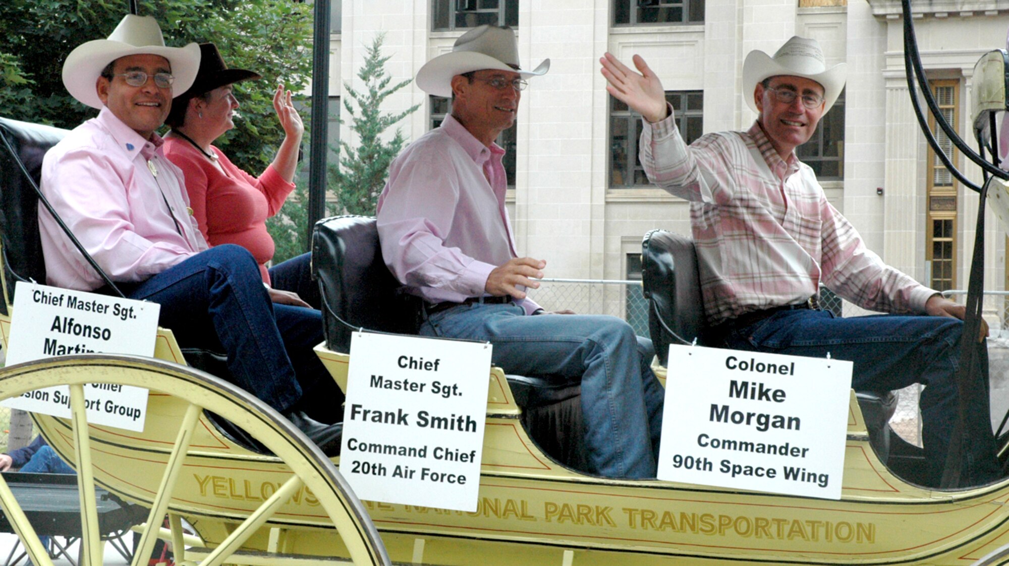Col. Mike Morgan, 90th Space Wing commander; Chief Master Sgt. Franklin Smith, Twentieth Air Force command chief; and Chief Master Sgt. Alfonso Martinez, 90th Mission Support Group and his wife, Anita, participate in the Cheyenne Frontier Days Parade July 26. July 26 was “Tough Enough to Wear Pink” day when people wore pink to support breast cancer and recognized the more than 300 people in Wyoming with breast cancer (Photo by Airman Alex Martinez).