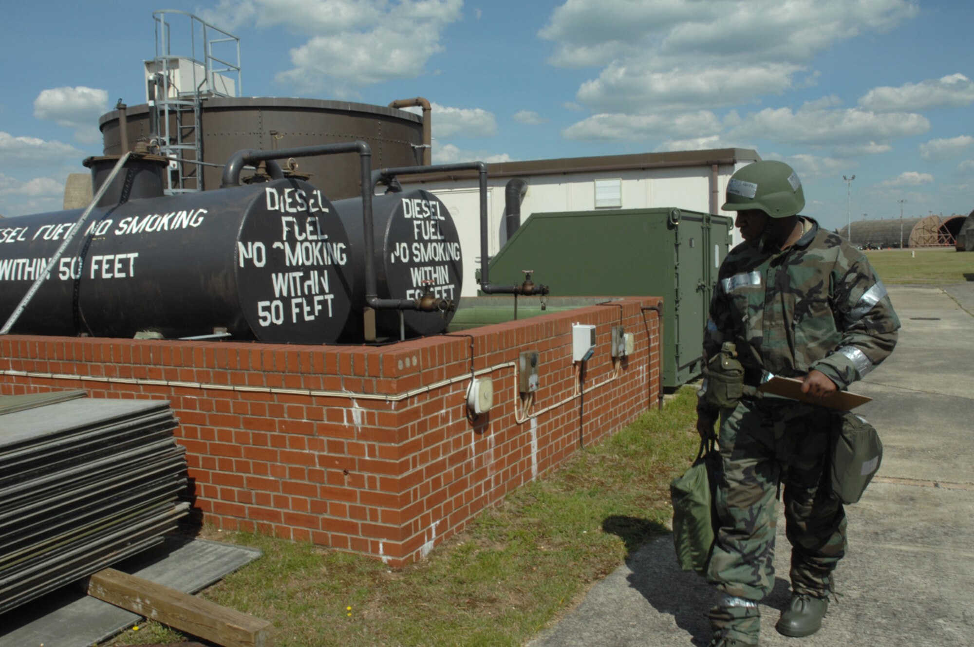 Staff Sergeant Jermaine Harvey, 493th Fighter Squadron, conducts a sweep to check for unexploded ordnance outside of the squadron operations center during an Operations Evaluation here July 31. In the simulation the squadron operations center was damaged by mortar fire. (U.S. Air Force photo by Airman First Class John Easterling)