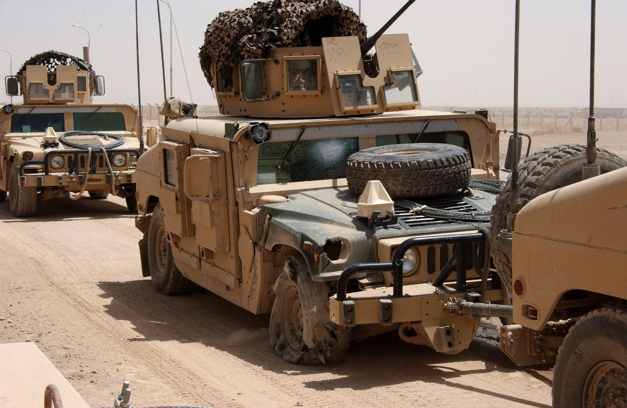 A 732nd Expeditionary Security Forces Squadron Det. 1 police transition team returns to Contingency Operating Base Speicher towing one its Humvees after it struck an improvised explosive device July 29 in Iraq. No one was injured in the blast. (U.S. Air Force photo/Master Sgt. Steve Horton)