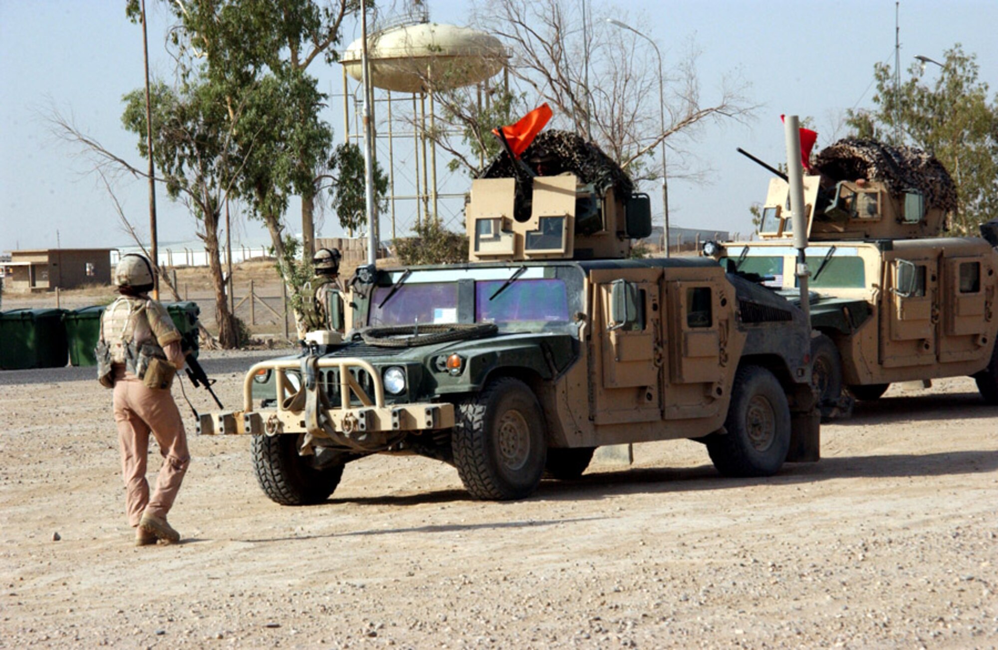 Staff Sgt. Jessica Mohney exercises the gunner's response to an escalation of force incident during premission battle drills in July at Contingency Operating Base Speicher, Iraq. The drills are designed to simulate any possible situation the team may encounter while conducting missions outside the wire. Sergeant Mohney is assigned to the 732nd Expeditionary Security Forces Squadron Det. 1 police transition team. The police transition team's goal is to help the Iraqis establish a functioning, independent police force. (U.S. Air Force photo/Master Sgt. Steve Horton) 

