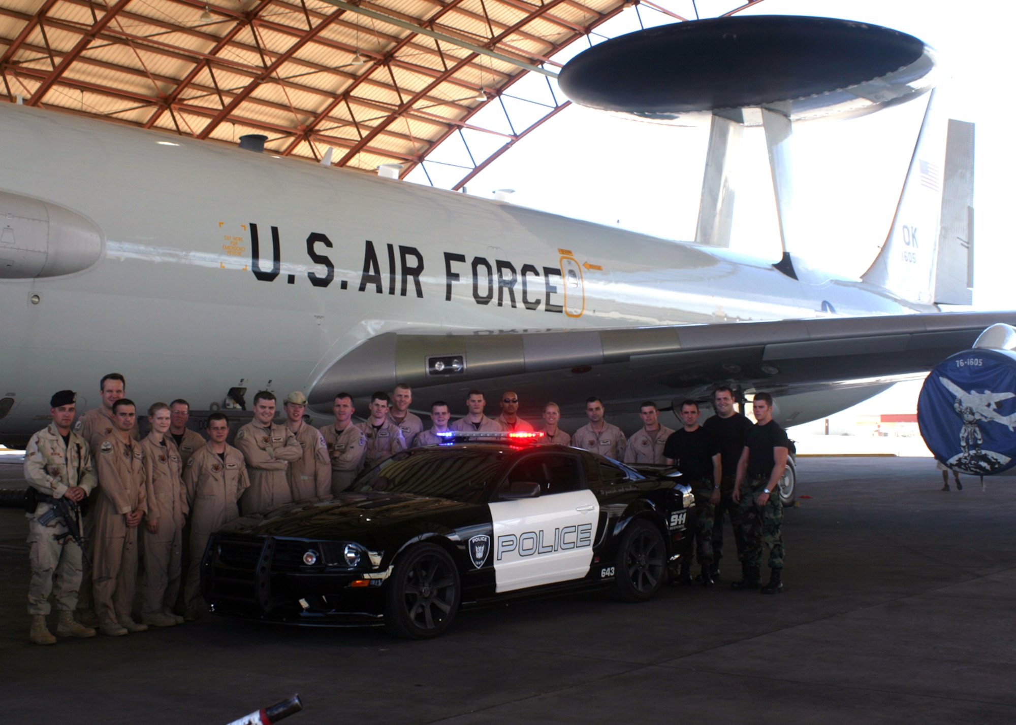 Members of Tinker's 552nd Air Control Wing and 72nd Security Forces Squadron pose with and E-3 Sentry aircraft and "Barricade," the police car Decepticon from "Transformers: The Movie," during filming at Edwards Air Force Base, Calif., September 2006.  (Photo by Capt. Corinna Jones)