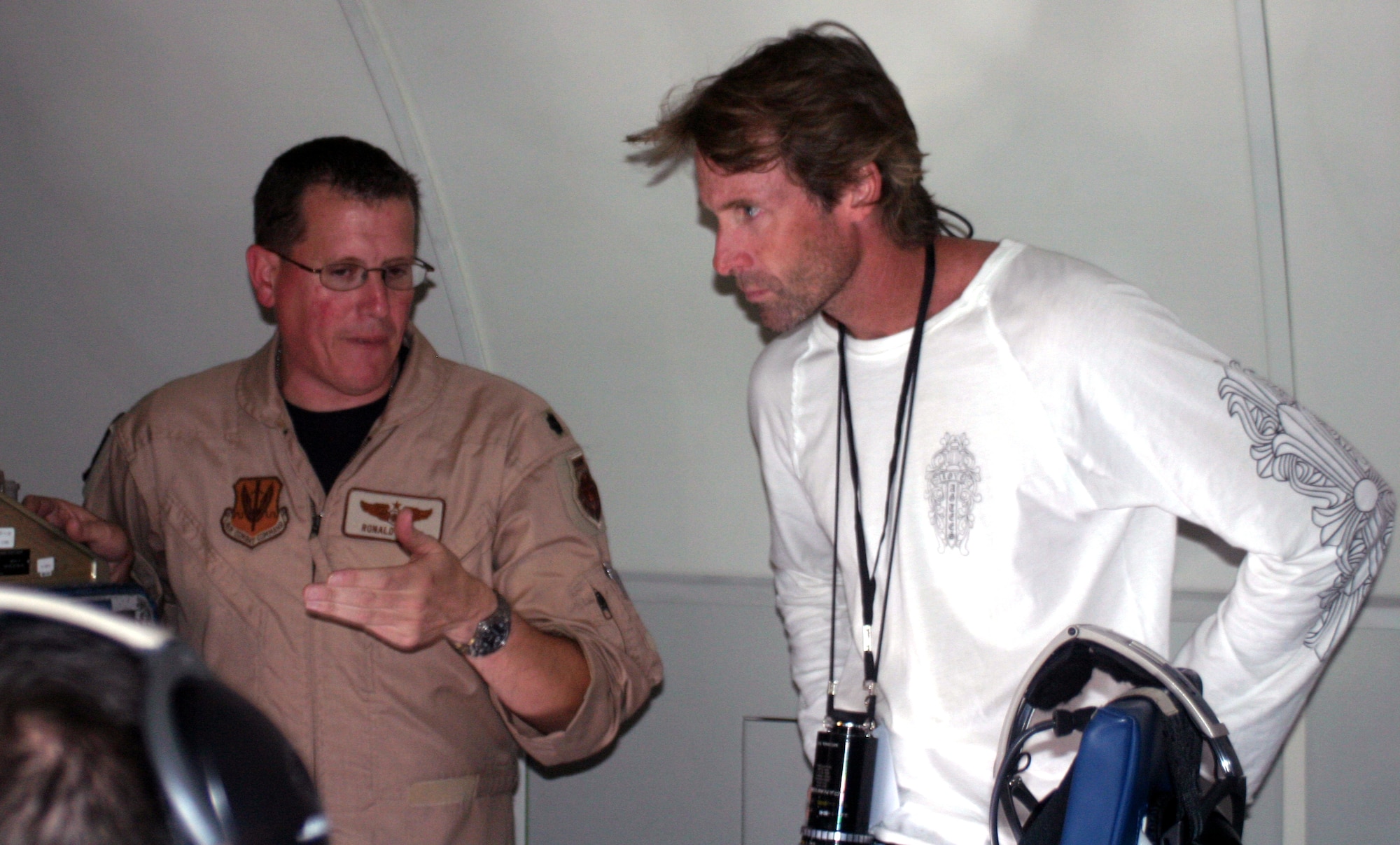 Lt. Col. Ronald Henry, 965th Airborne Air Control Squadron, speaks with Michael Bay, director of "Transformers: The Movie," about what kinds of footage film crews will be able to get.  At first, the creators of "Transformers" only intended external shots of the E-3 Sentry, but after getting more information from the 965th AACS the director decided to try internal footage - with realistic military lingo - as well. (Photo by Capt. Corinna Jones)