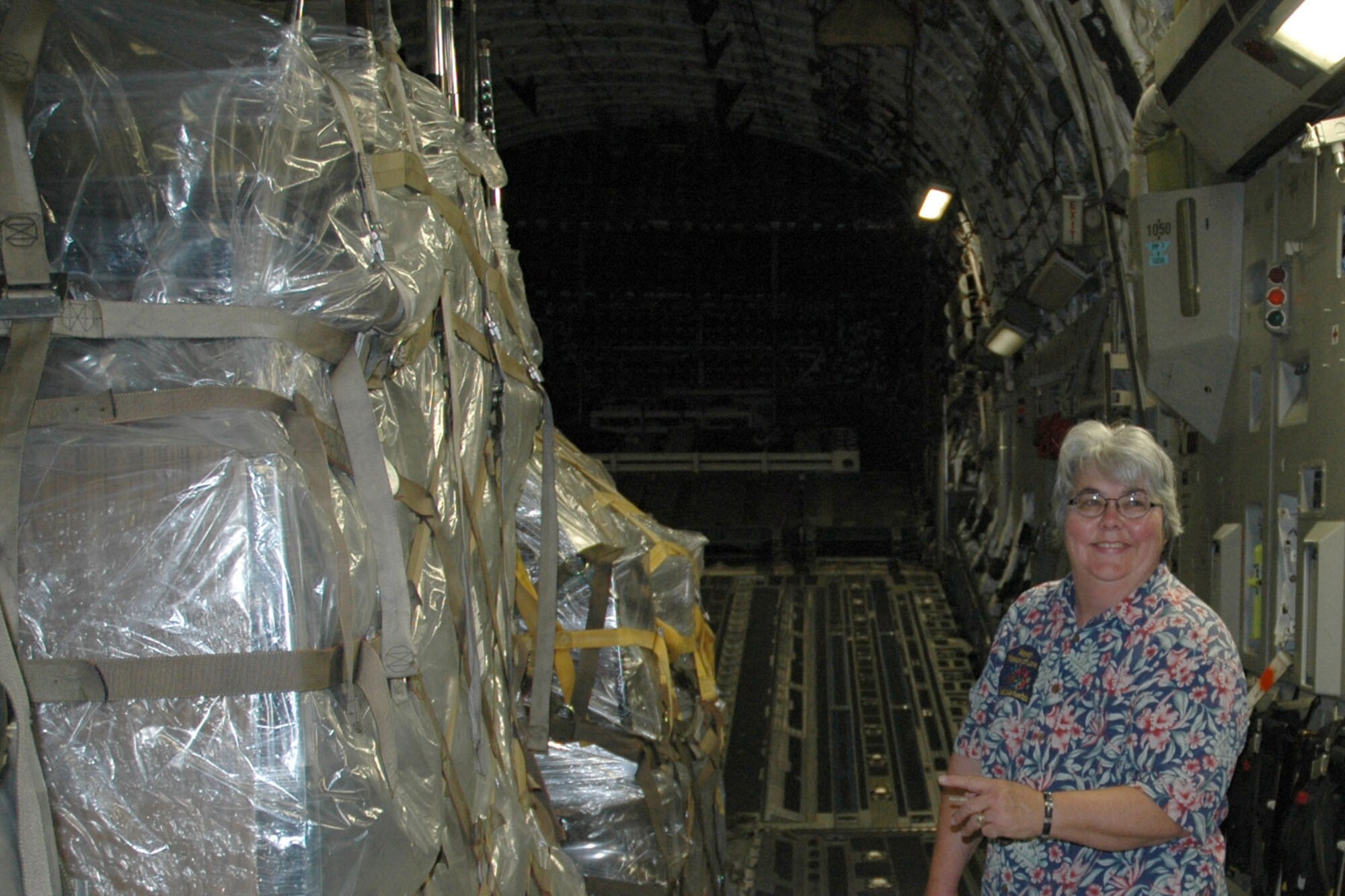 YOUNGSTOWN AIR RESERVE STATION, Ohio - Kathleen Price, founder and director of the "Mission of Love Foundation," points to a pallet on board a C-17 cargo aircraft being loaded on the ramp here. The pallet is part of nearly nine tons of educational supplies being sent to four rural schools in Belize, Central  America. Ms. Price's Youngstown, Ohio-based non-profit group organized the humanitarian effort of airlifting the school supplies through the Denton Program. More information about this program can be found on the web at www.usaid.gov. U.S. air Force photo/Tech. Sgt. Bob Barko Jr. 