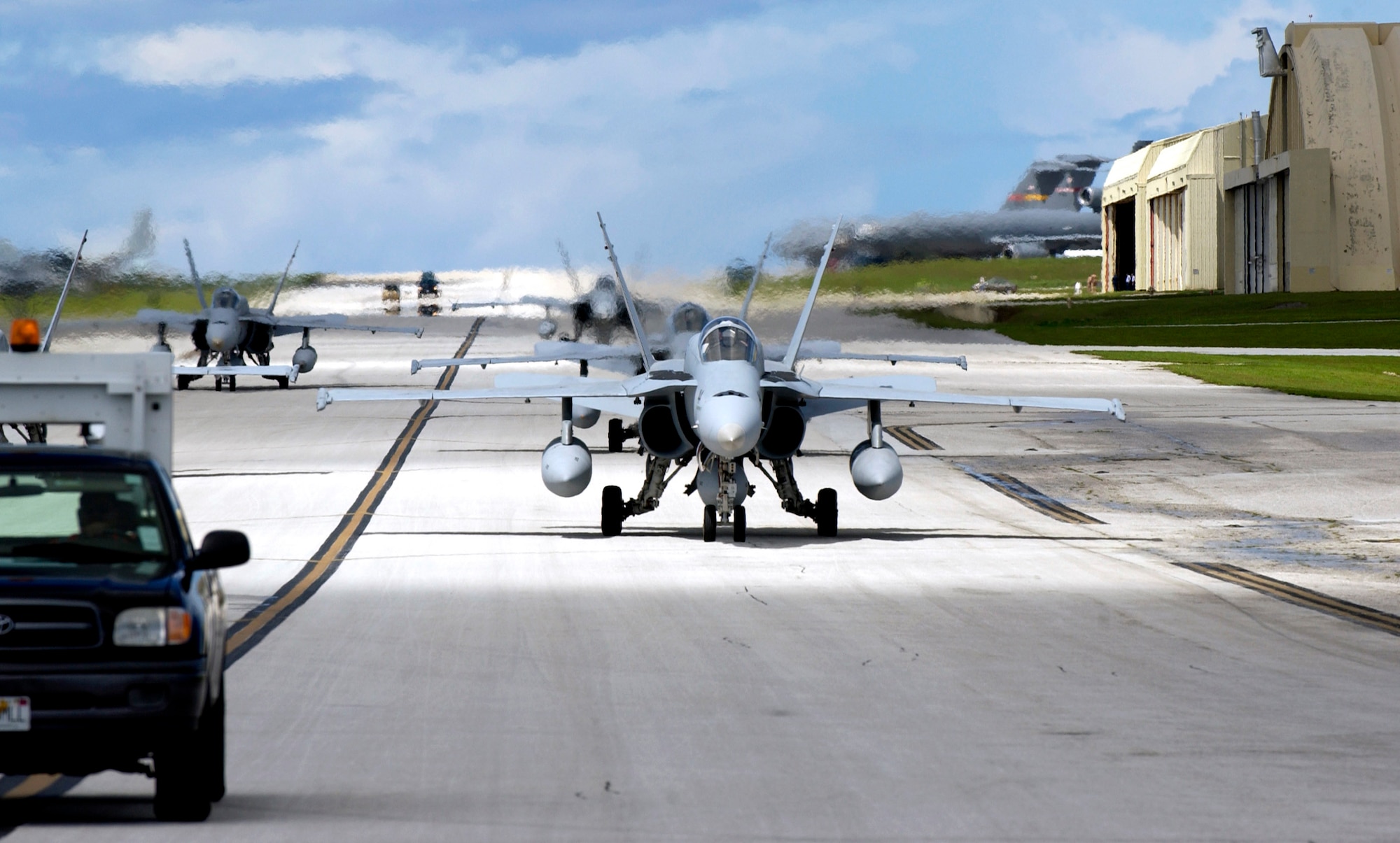 Navy F-18 Hornets from the Naval Air Station's Joint Reserve Base in New Orleans arrive to take part in the Valiant Shield exercise Aug. 6 at Andersen Air Force Base, Guam. During the exercise, Air Force aircraft and Airmen from stateside bases and Kadena Air Base, Japan, will comprise part of an expeditionary air wing based at Andersen AFB. Andersen AFB will also be the beddown location for approximately 64 Air Force and 29 Navy aircraft, plus transient aircraft, during Valiant Shield. (U.S. Air Force photo/Senior Airman Miranda Moorer) 
