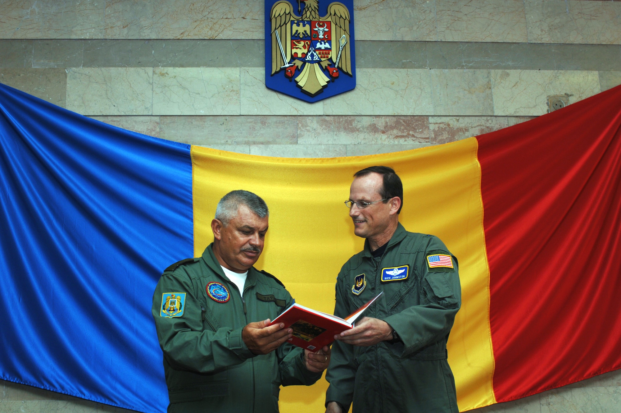 Brig. Gen. Costel Tataru, Romania Air Force Main Air Operational Center deputy commander, and Brig. Gen. Rich Johnston, KMC and 86th Airlift Wing commander, discuss future operations in Romania at Mihail Kogalniceanu Air Base, Romania, July 24. (U.S. Air Force Photo/ MSgt Timothy Cook)