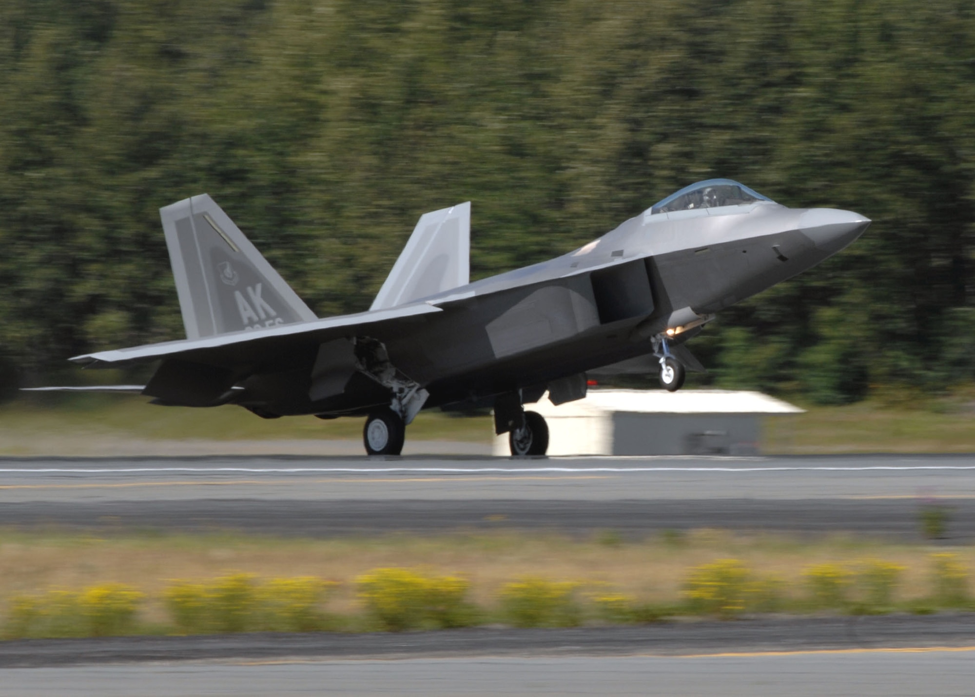 An F-22 Raptor touches down at Elmendorf Air Force Base, Alaska, during a ceremony marking the aircraft's arrival Aug. 8. Elmendorf became the second operational base and the first Pacific Air Forces installation to receive the aircraft. The F-22 performs both air-to-air and air-to-ground missions allowing full realization of operational concepts vital to the 21st century Air Force. (U.S. Air Force photo/Airman 1st Class Laura Turner)
