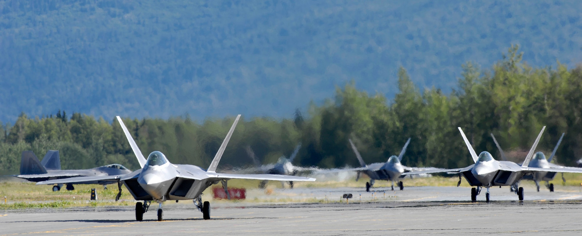 Six F-22 Raptors taxi following touchdown at Elmendorf Air Force Base, Alaska, during a ceremony marking the aircraft's arrival Aug. 8. The F-22s will join the active duty 3rd Wing and Air Force Reserve Command's 477th Fighter Group here. The 477th FG becomes the first Air Force Reserve unit to operate and maintain the F-22. (U.S. Air Force photo/Tech. Sgt. Keith Brown)