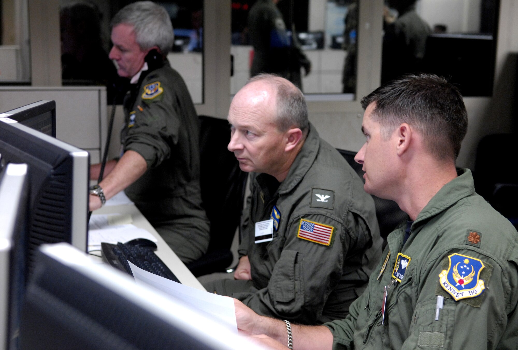 HICKAM AIR FORCE BASE, Hawaii -- Joint service personnel coordinate air assets Aug. 7 in the air operations center during Exercise Valiant Shield. Valiant Shield is a week-long exercise, which tests the military’s ability to rapidly consolidate joint forces in response to regional contingencies, involves approximately 22,000 troops, 30 ships and some 275 aircraft. (U.S. Air Force photo/Tech. Sgt. Shane A. Cuomo) 