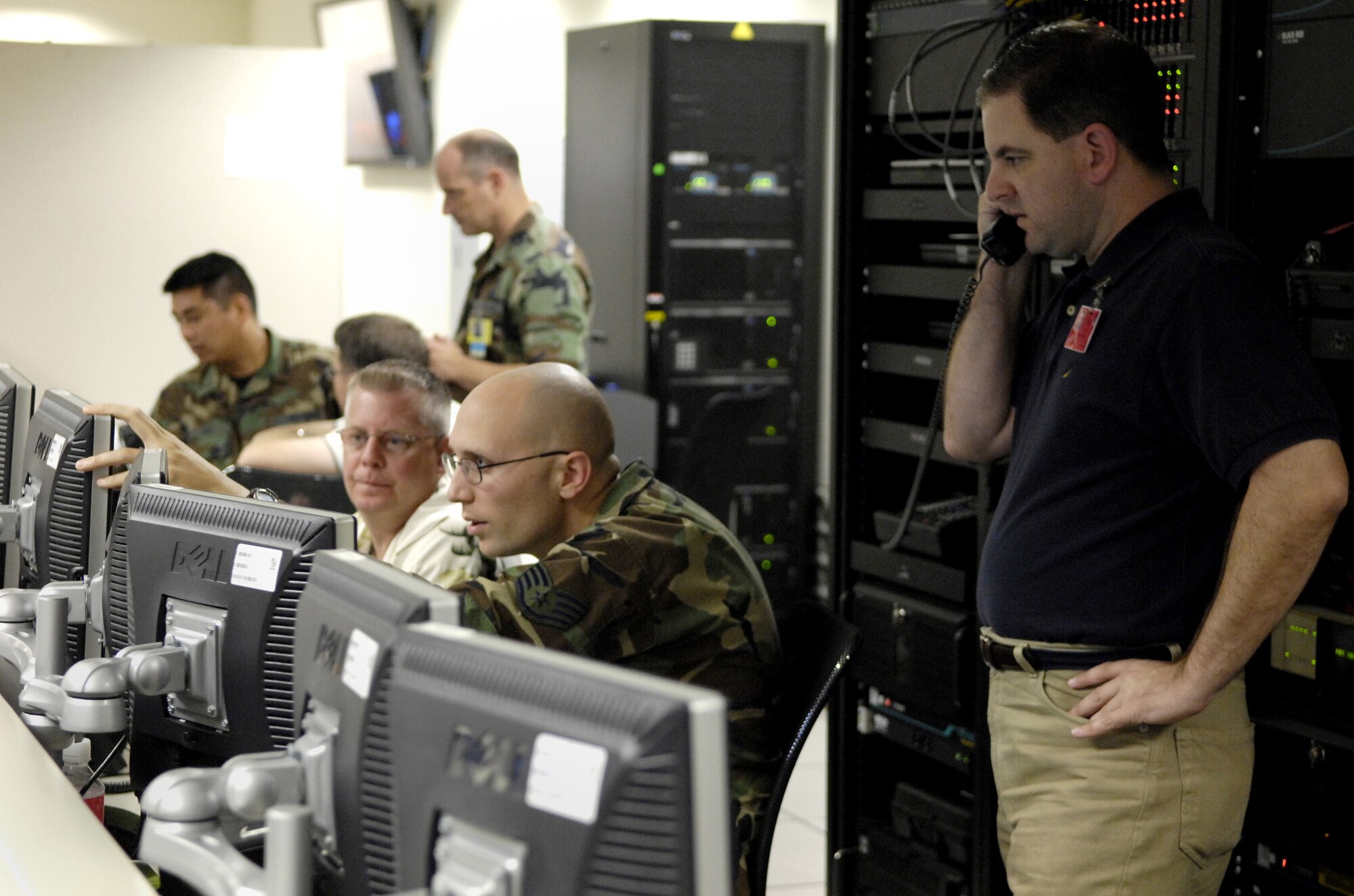 HICKAM AIR FORCE BASE, Hawaii -- Members of joint interface control cell pull in real time images for operations Aug. 7 in the air operation center here during Exercise Valiant Shield. The joint interface control cell manages data links for the AOC. Valiant Shield is a week-long exercise, which tests the military’s ability to rapidly consolidate joint forces in response to regional contingencies, involves approximately 22,000 troops, 30 ships and some 275 aircraft. (U.S. Air Force photo/Tech. Sgt. Shane A. Cuomo) 