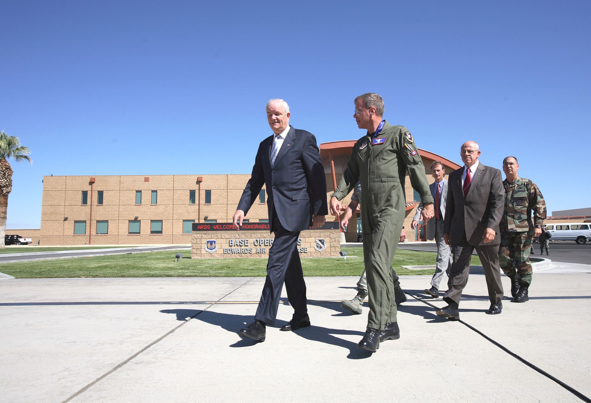 Secretary of the Air Force Michael W. Wynne and Maj. Gen. Curtis Bedke, Air Force Flight Test Center commander, walk to a ceremony at Edwards Air Force Base, Calif., Aug. 8. During the ceremony, Secretary Wynne certified Fischer-Tropsch synthetic fuel blends for use in the B-52H Stratofortress. Following Secretary Wynne and General Bedke are Jerold Smith (center), chief engineer with the 327th Aircraft Sustainment Group at Tinker AFB, Okla.; Timothy Dues (second from right), deputy director for Maintenance, Logistics Directorate, Wright-Patterson AFB, Ohio; and Col. Michael Hirka (far right), 327th ASG commander. (U.S. Air Force photo/Jet Fabara)