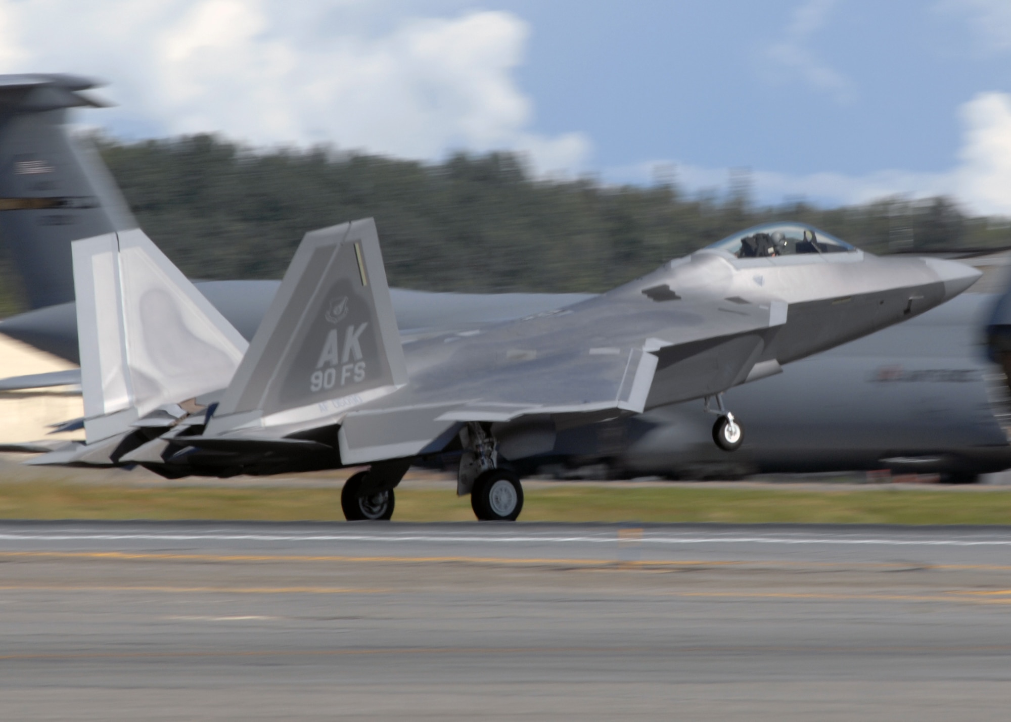 Elmendorf Air Force Base, Alaska -- The first of 40 F-22A Raptors lands during an arrival ceremony here Wednesday. The aircraft, which will be flown and maintained by the active-duty Air Force's 90th Fighter Squadron and Air Force Reserve 302nd Fighter Squadron, is the first to be permanently base outside of the contiguous United States. (U.S. Air Force photo by Airman 1st Class Laura Turner)