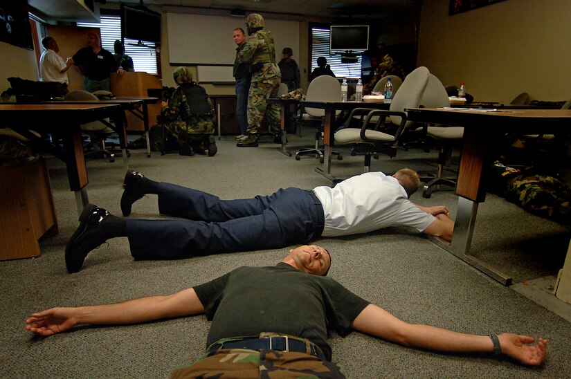 Staff Sgt. Louis Wall, 437th Civil Engineer Squadron emergency management apprentice, plays dead on the floor as others wait as hostages in the 437th Civil Engineer Squadron readiness flight building on base Aug. 1. Team Charleston participated in a base-wide exercise that simulated an emergency scenario similar to what happened at Virginia Tech. (U.S. Air Force photo/Airman 1st Class Nicholas Pilch)