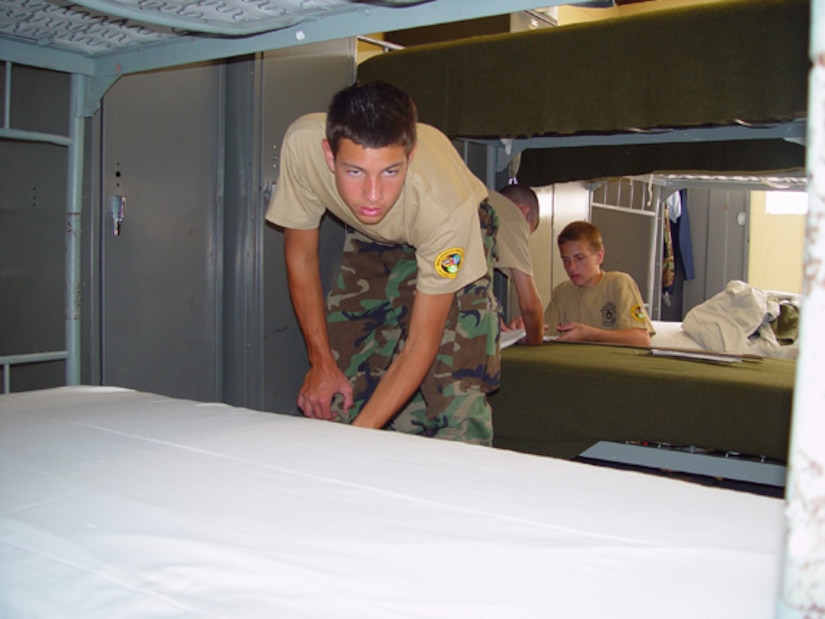 Cadet 2nd Lt. Nicholas Clegg, 16, examines his bed to make sure it's just right before a recent summer encampment inspection at the McRady Army National Guard training site near Columbia, S.C. (courtesy photo)   
