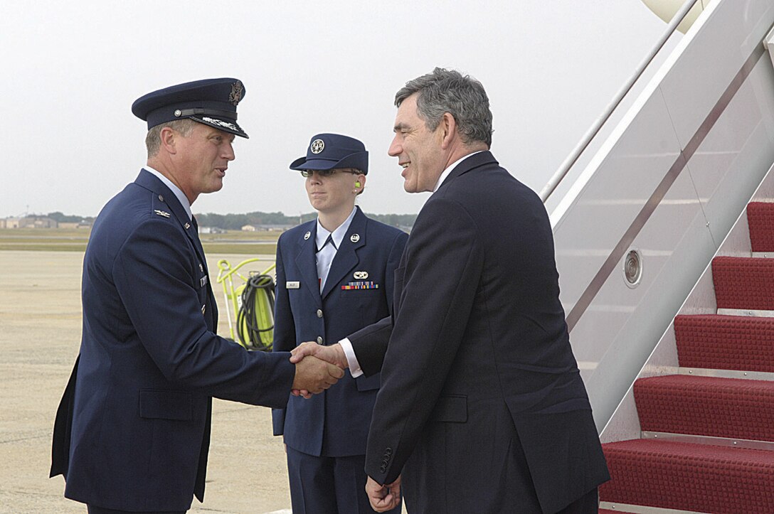 Prime Minister Gordon Brown of Britain shakes the hand of Col. Kenneth Volmert, 316th Operations Group commander, prior to boarding his jet Monday. This was the prime ministers first official trip to the United States to meet with President George W. Bush at Camp David.