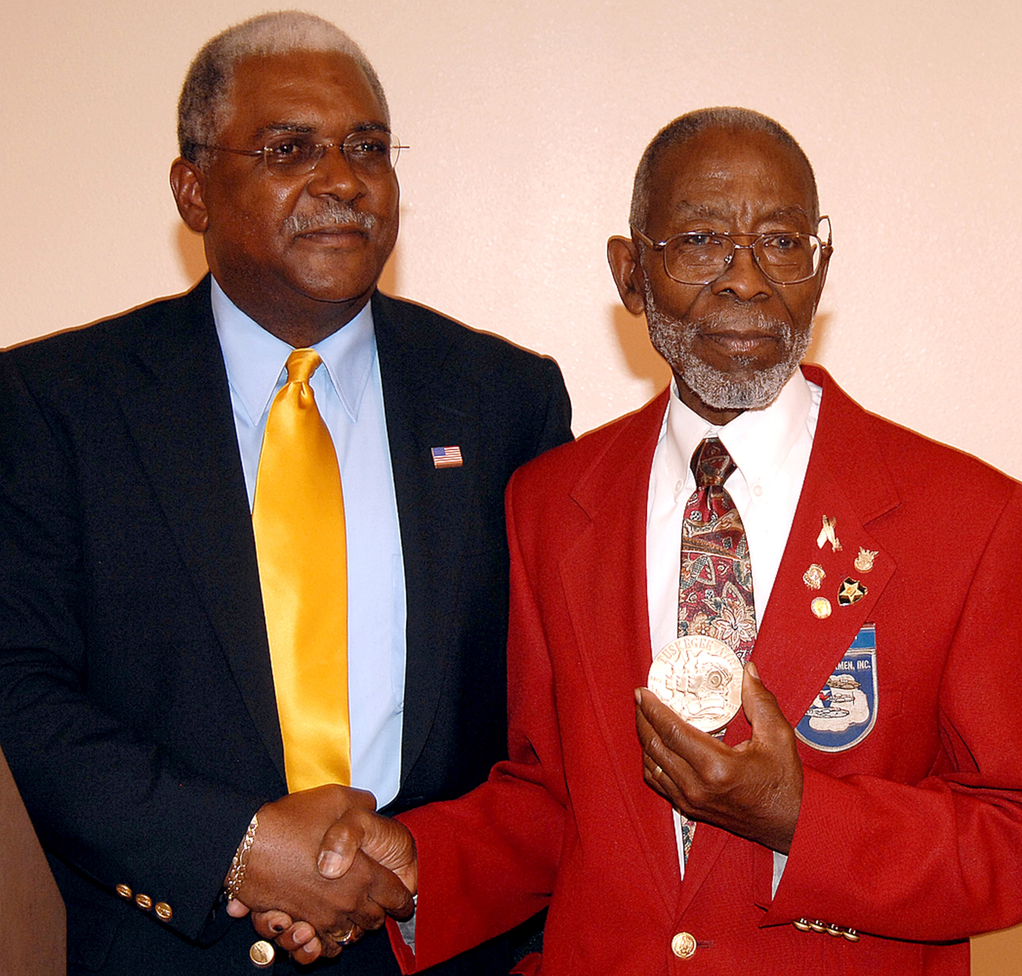 John Allen, a Tuskegee Airman, receives a Congressional Gold Medal of Honor from Stanley Allen, of the Albuquerque office of New Mexico Senator Jeff Bingaman. Mr. Allen was not able to attend the ceremony when approximately 300 original Tuskegee Airmen were presented the Congressional Gold Medal of Honor in March in Washington, D.C. U.S. Air Force photo by Todd Berenger