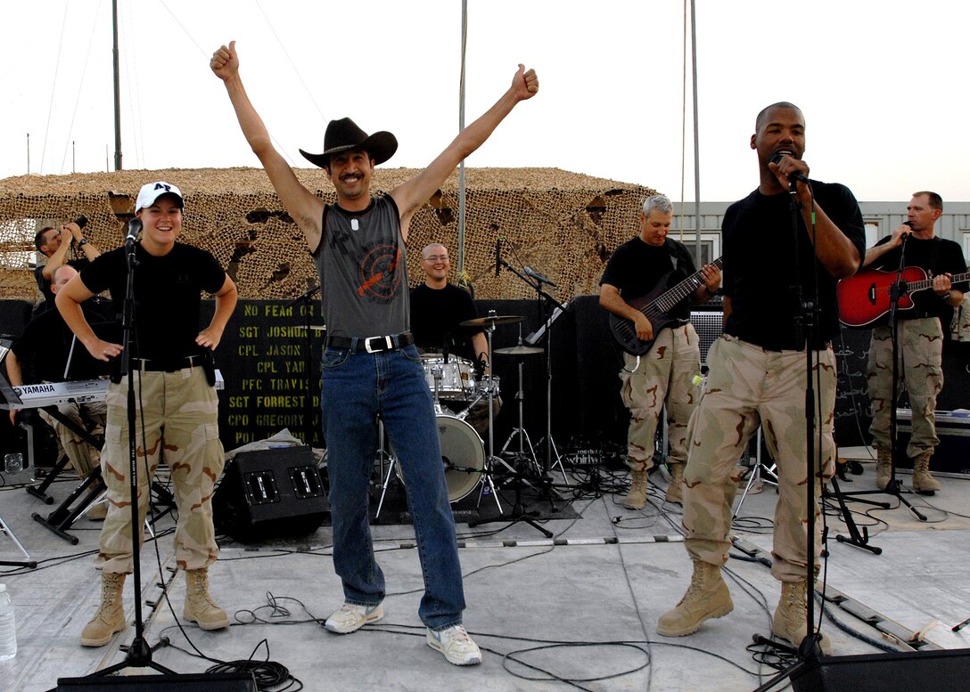 Ameen, an Iraqi worker at Forward Operating Base McHenry, Iraq, joins the U.S. Central Command Air Forces Band "Live Round" on stage July 15. The band is on a 60-day deployment performing throughout Iraq and Afghanistan. (U.S. Air Force photo/Chief Master Sgt. John A. Zincone)