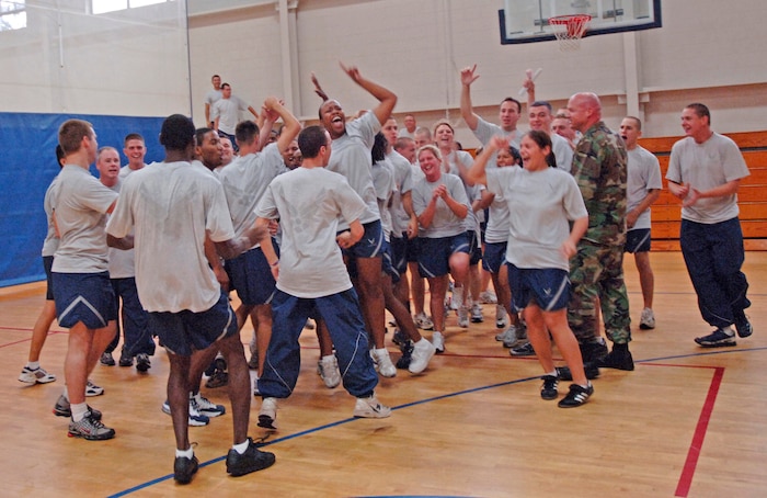 The 437th Logistics Readiness Squadron celebrates after their win at the  commander's fitness challenge dodgeball tournament held at the base Fitness and Sports Center Aug. 3. (U.S. Air Force Photo/Staff Sgt. April Quintanilla)