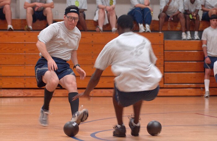 Nelson Novo, 437th Airlift Wing, races against Dion Scott, 437th Communications Squadron, for the nearest ball during the base-wide dodgeball tournament held at Fitness and Sports Center. (U.S. Air Force Photo/Staff Sgt. April Quintanilla)