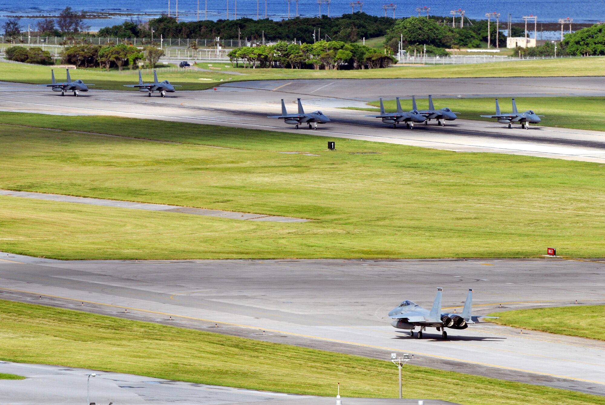 F-15 Eagles from Kadena Air Base, Japan, taxi down the flightline at Kadena Air Base, Japan, Aug. 5 enroute to Guam. The fighters are taking part in the 22,000-plus participant, joint service exercise Valiant Shield which runs through Aug. 14. (U.S. Air Force photo/Senior Airman Darnell T. Cannady)