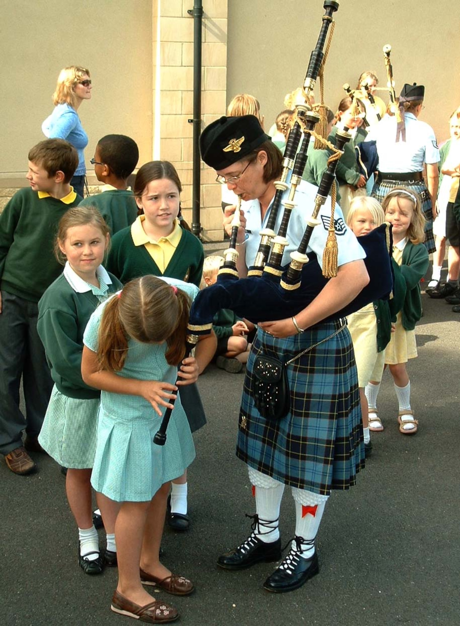 FAIRFORD, United Kingdom -- Staff Sgt. Shane Stanke and school children from the Kempford School in Fairford, U.K., investigate whether playing the bagpipes with multiple people is easier than trying to do it alone. The U.S. Air Force Reserve Pipe Band performed for school children at seven different schools surrounding RAF Fairford. (U.S. Air Force photo/Staff Sgt. Eric Frank)