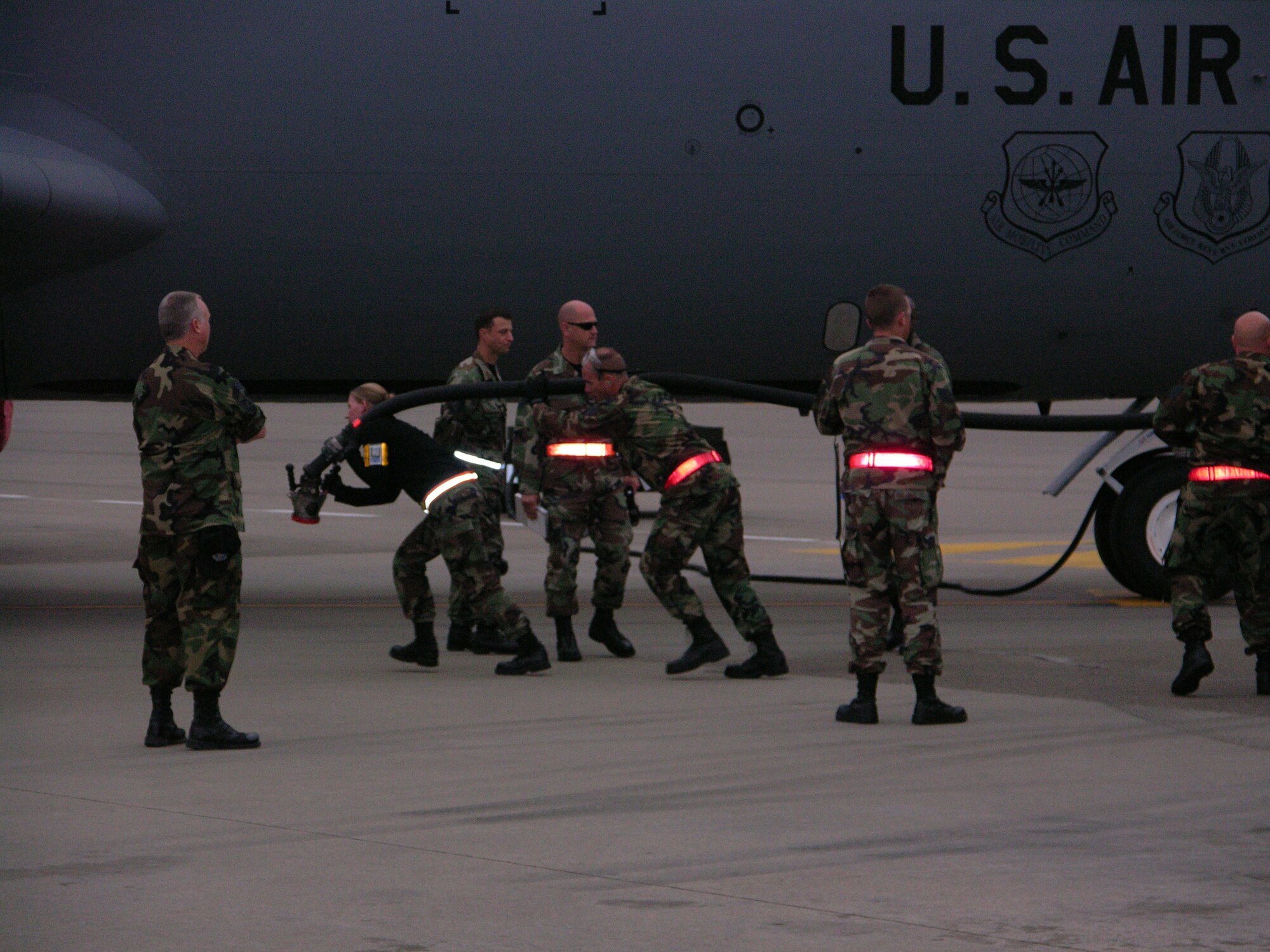 SEYMOUR JOHNSON AIR FORCE BASE, N.C. --Members of the 916th Aircraft Maintenace Squadron pull on the gasoline hose to hook it to the KC-135R to receive gas.  The airplane will then be ready for another phase of competition during the Air Mobility Command's Rodeo 2007.