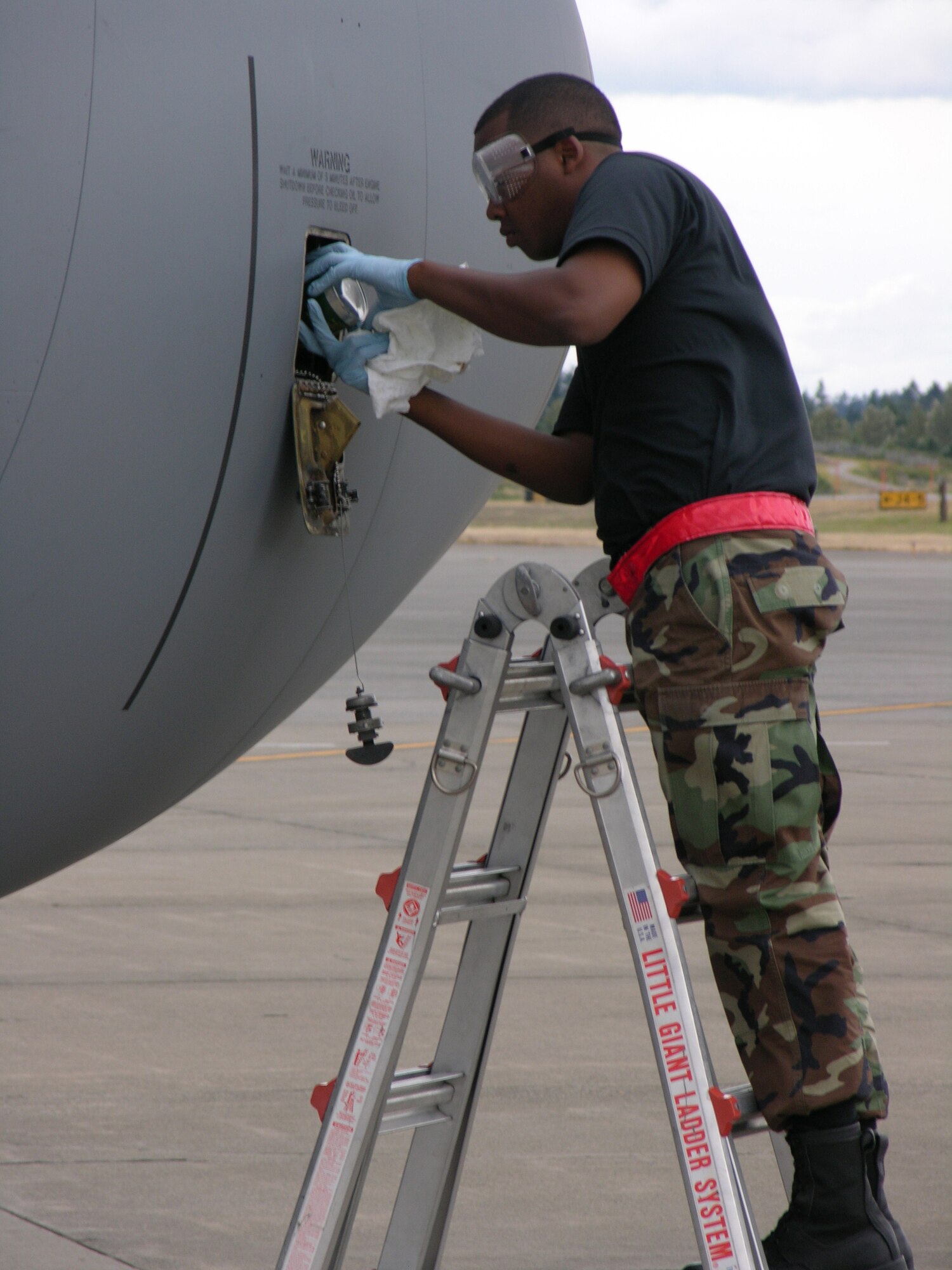 SEYMOUR JOHNSON AIR FORCE BASE, N.C. -- One last check of the oil before take-off was done by Tech. Sgt. Wihwaht Thompson during Air Mobility Command's Rodeo 2007.  Sergeant Thompson is a KC-135R crew chief assistant with the 916th Aircraft Maintenance Squadron.