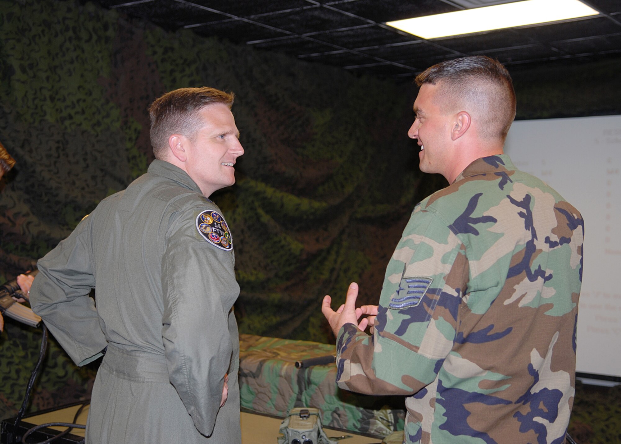 Colonel Jeff Dunn, 14th Flying Training Wing vice commander, talks with Tech. Sgt. James Robertson, 14th Security Forces Squadron, during his immersion Aug. 2. (U.S. Air Force Photo by Elizabeth Owens)