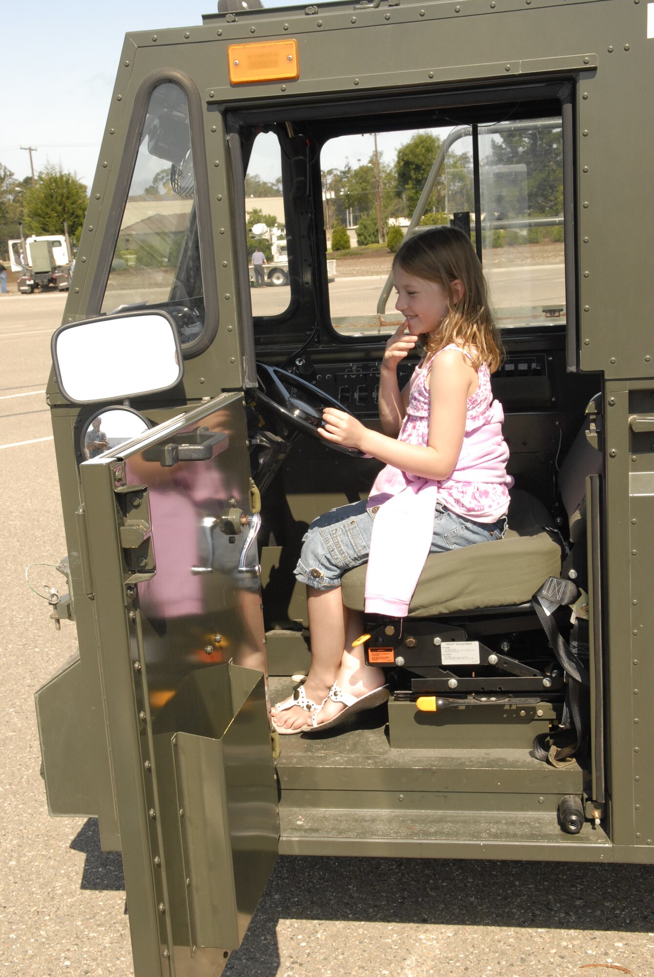 VANDENBERG AIR FORCE BASE, Calif. -- Kaitlyn Bolles 7, pretends to operate a 30-ton aircraft cargo loader during the 30th Space Wing Touch-a-Truck event on Aug. 4.  The Touch-a-Truck event is sponsored every year by the 30th Services Division to allow parents and their children to get a hands on look at fire engines, armored humvees, loaders, 30-ton aircraft cargo loaders and transporters, and launch vehicle tracking stations work. (U.S. Air Force photo/Airman 1st Class Adam Guy)
