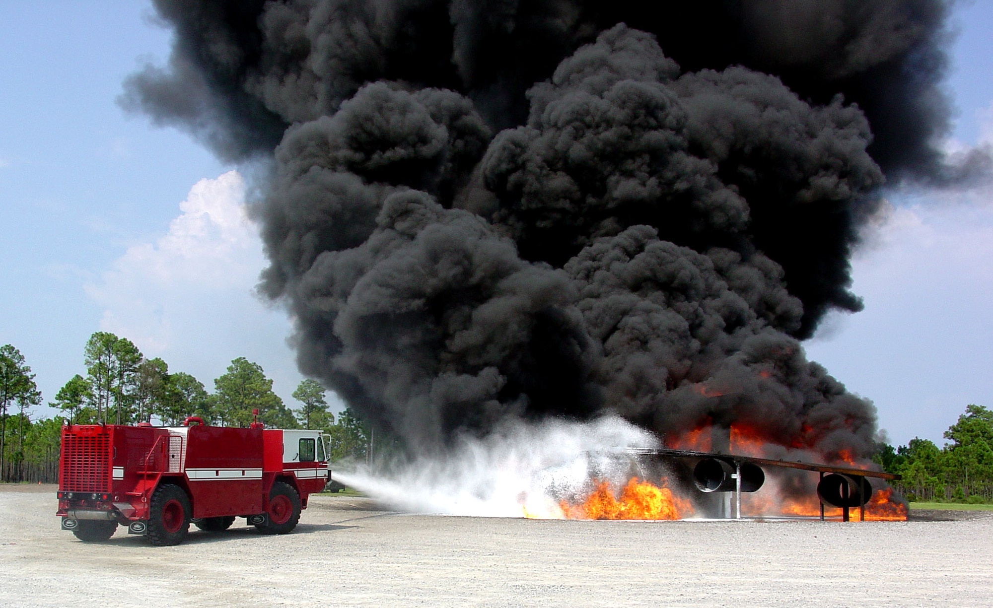 A UHP P-19 truck extinguishes a fire during testing July 15 at Tyndall Air Force Base, Fla. Air Force Research Laboratory scientists developed ultra high pressure firefighting technology that yields greater fire fighting capability from smaller, light-weight vehicles. Starting in fiscal 2008, these new trucks can be deployed in sets of two on a C-130 Hercules, whereas the former fire trucks could only be carried one at a time aboard the aircraft. (U.S. Air Force photo)