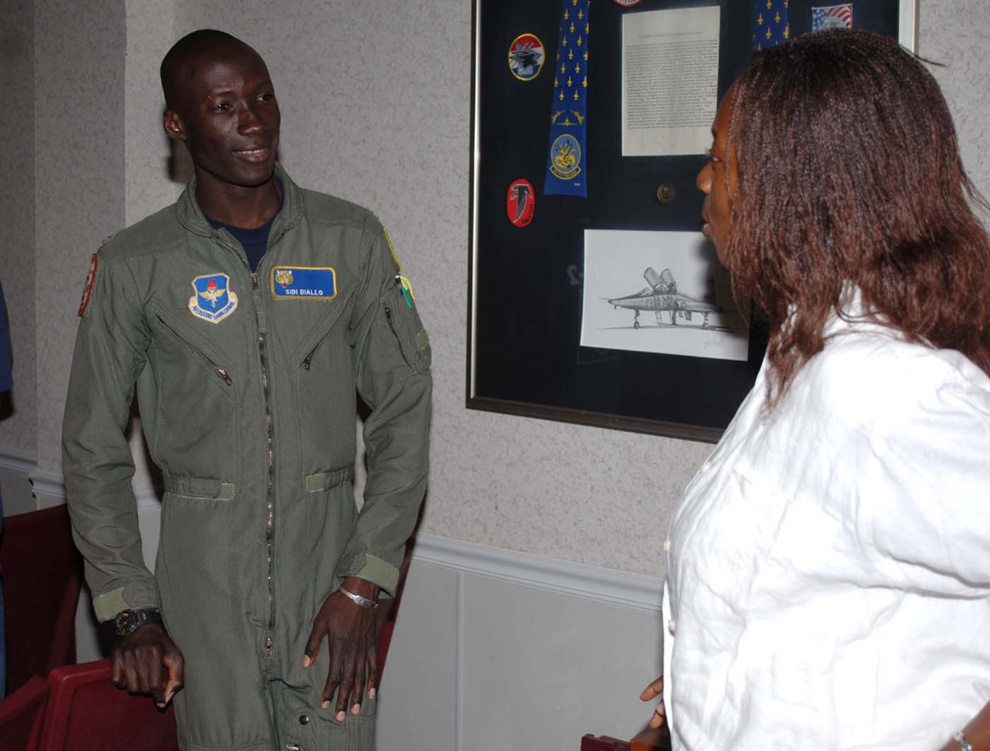 Second Lt. Sidi Diallo, Specialized Undergraduate Pilot Training Class 07-15 and an international student pilot from Mali, talks to a Fulbright Scholar Tuesday during a tour. The Fulbright Scholars toured Columbus AFB to to gain insight on the pilot training that takes place here. (U.S. Air Force Photo by Airman 1st Class Danielle Powell)