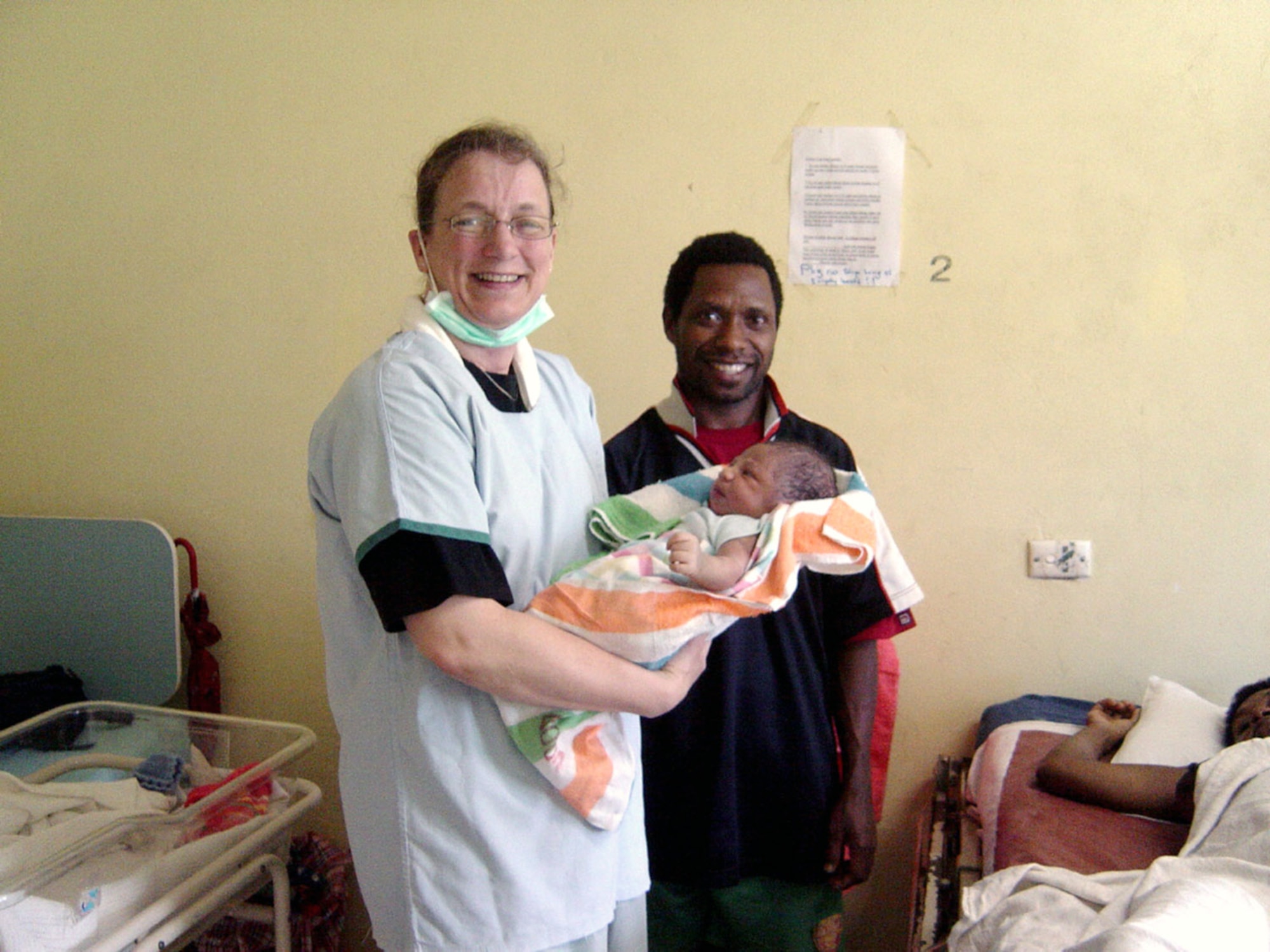 Capt. Christine Crawford holds a newborn baby July 25 at Espiritu Santo hospital in Vanuatu. Captain Crawford is a general medical surgical nurse assigned to the 3rd Wing from Elmendorf Air Force Base, Alaska. She was part of an obstetrics/gynecological surgical team that visited Espiritu Santo island in the nation of Vanuatu to train medical staff and perform surgery. The team was part of the Oceania Humanitarian Assistance Mission that brought medical, dental and engineering servicemembers to perform civil assistance projects on Vanuatu, Nauru and Kiribati July 20 through 30. (U.S. Air Force photo) 