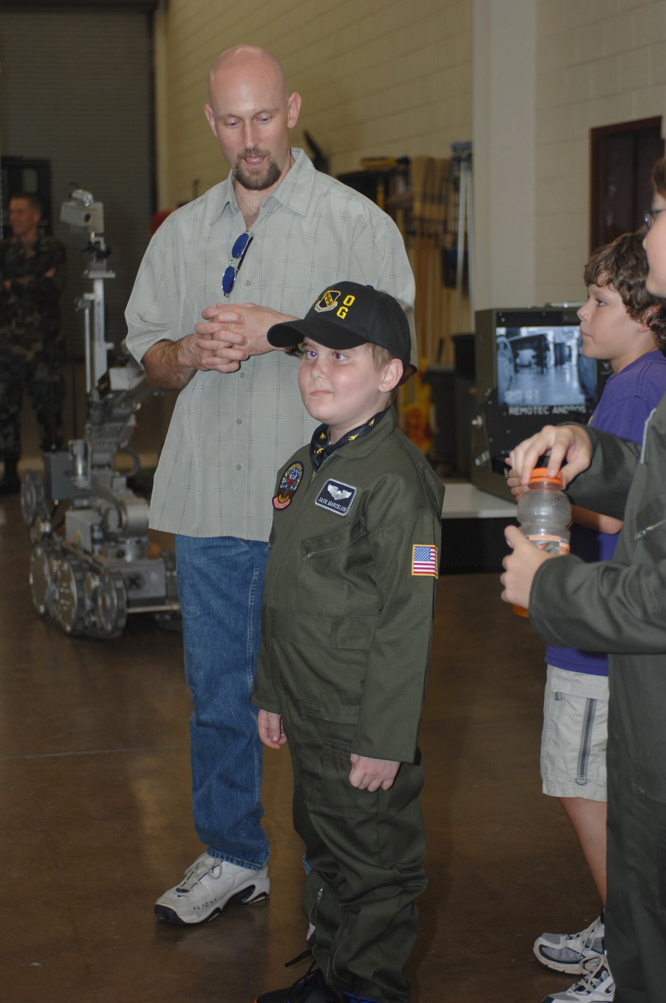 Jack and his father Rob Marcelain watch a demonstration by the 7th Civil Engineer Squadron Explosive Ordiance Disposal Flight August 1.